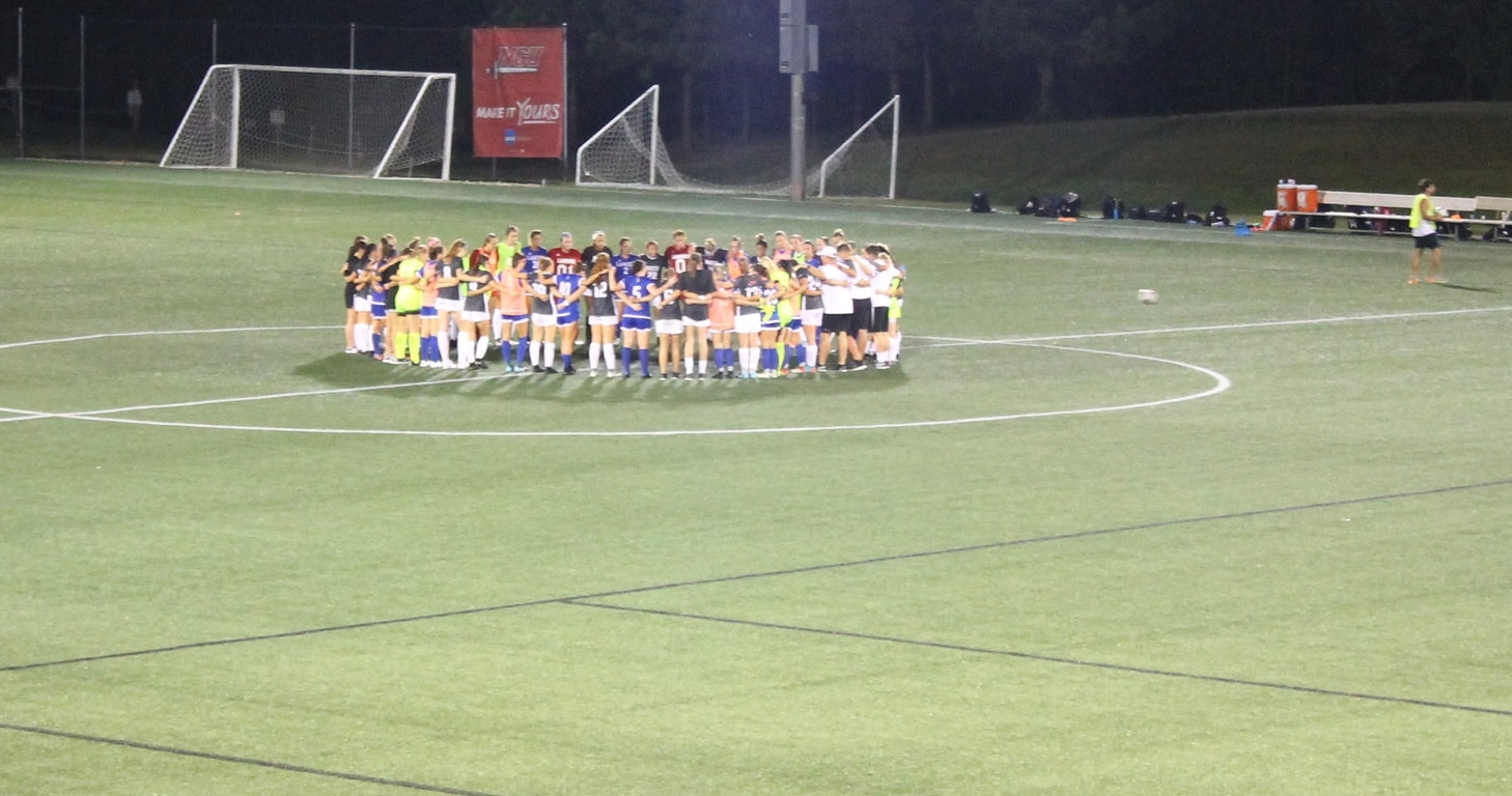 NGU and Lander University come together after the game to all pray together and shake hands.