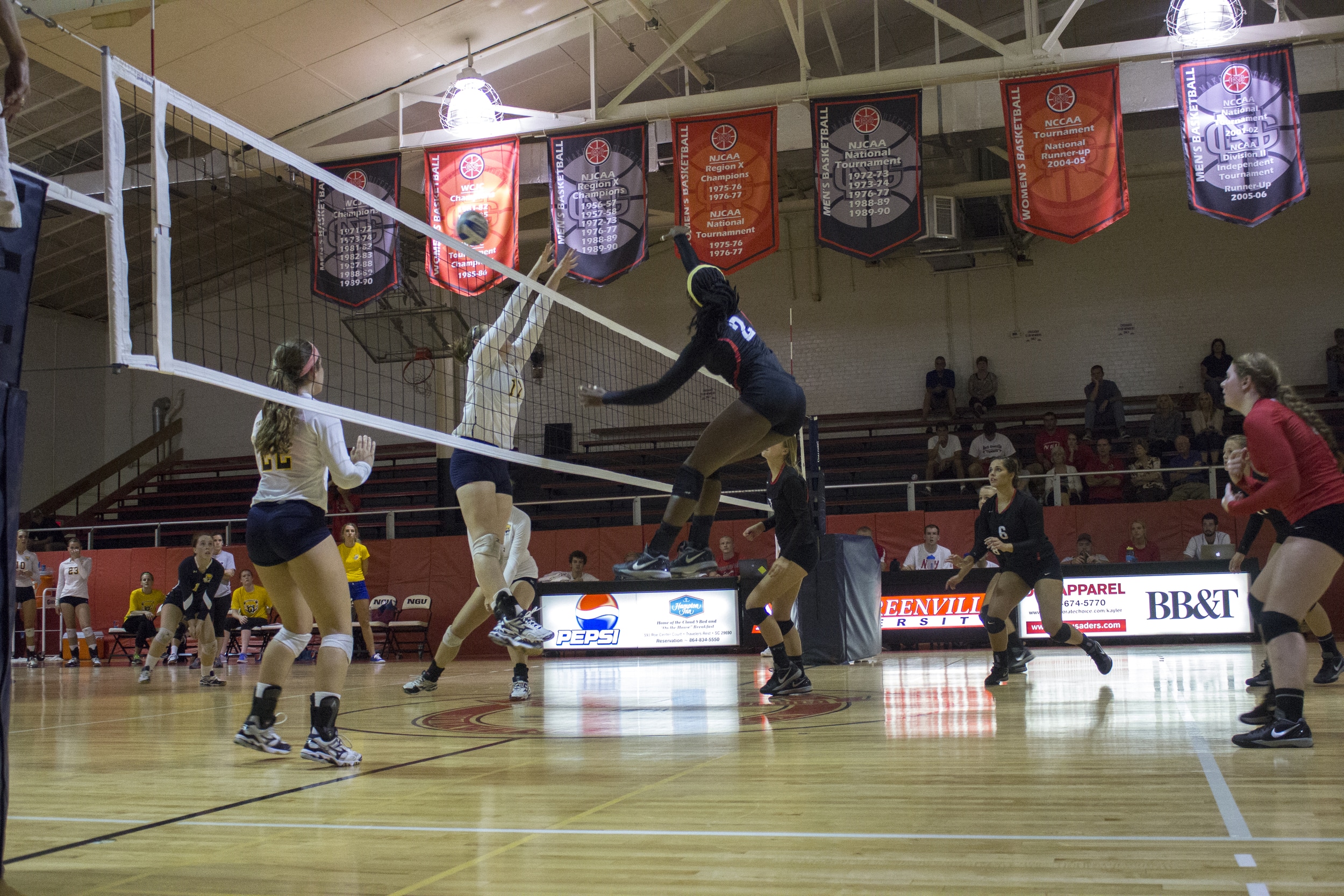  Junior Yomi Adeyeye stretches to spike the ball over the net.&nbsp; 