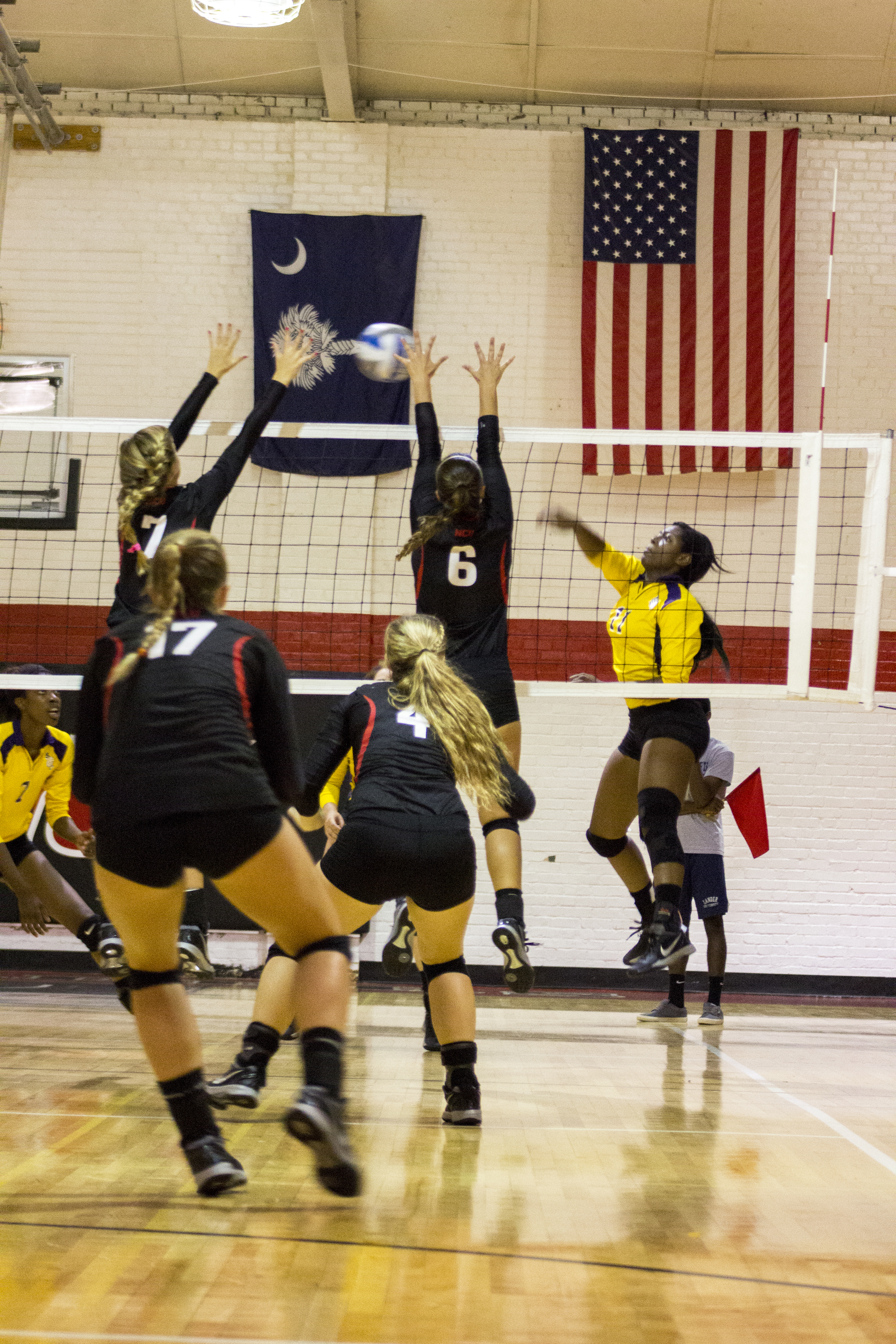  Senior Elizabeth James and sophomore Haley Hester jump up to block the oncoming spike. 