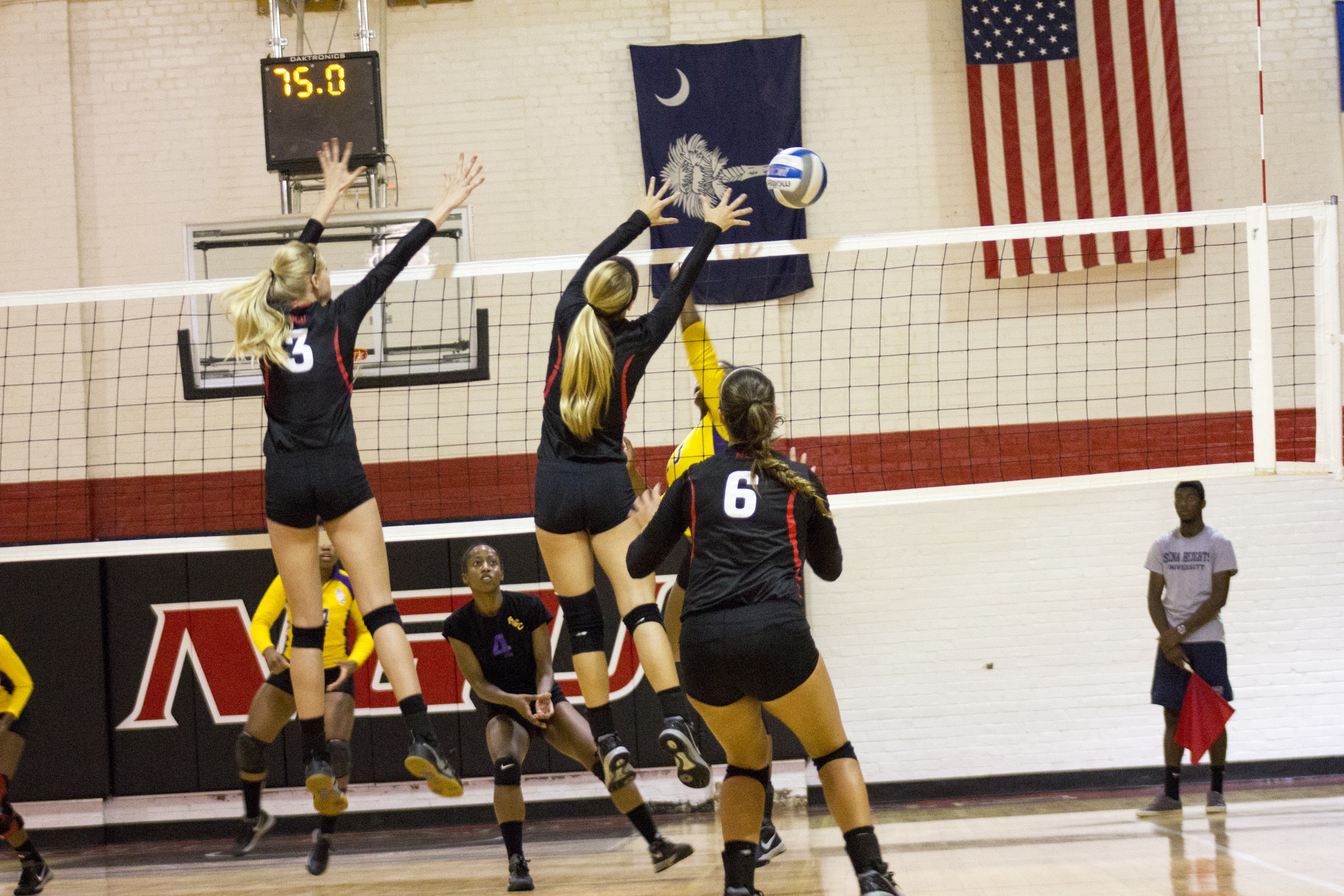  Sophomore Rachel Burts and junior Taylor Dupes stretch to block a spike. 