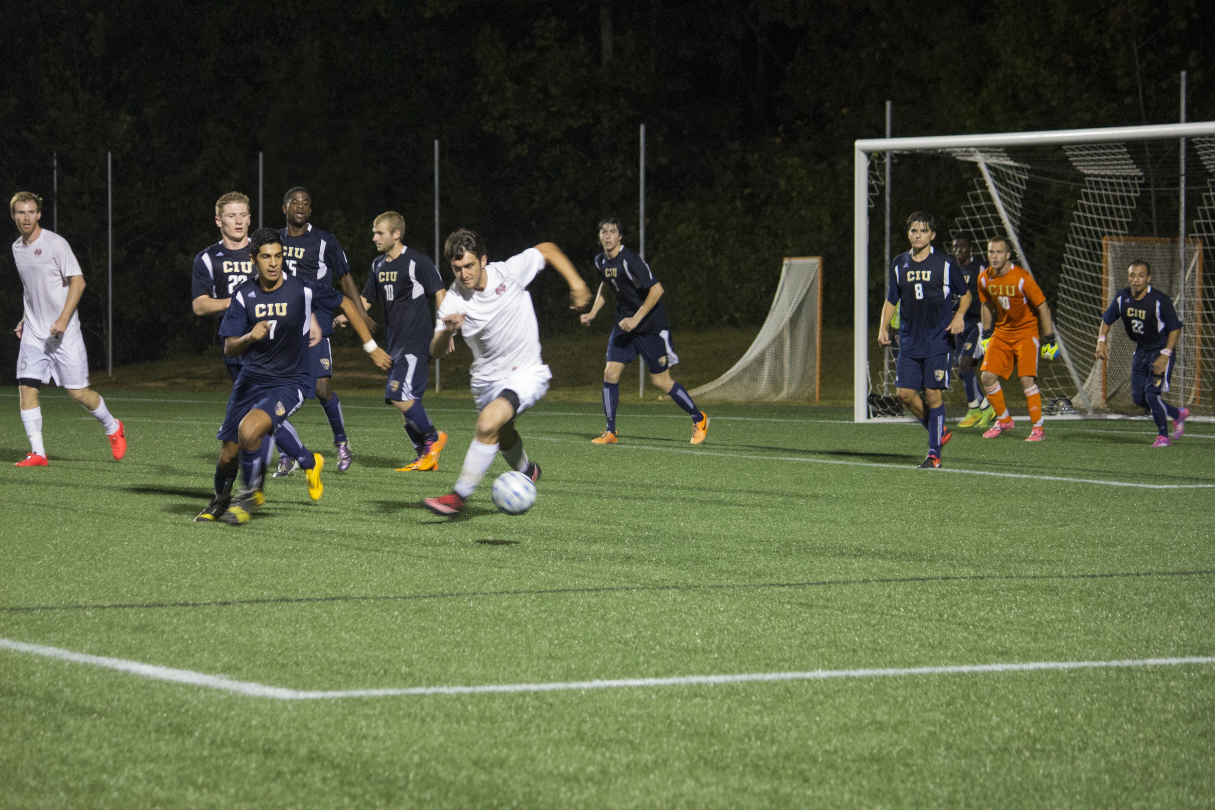  Junior Asa Wolfe sprints against defending Ram's player to get possession of the ball.&nbsp; 