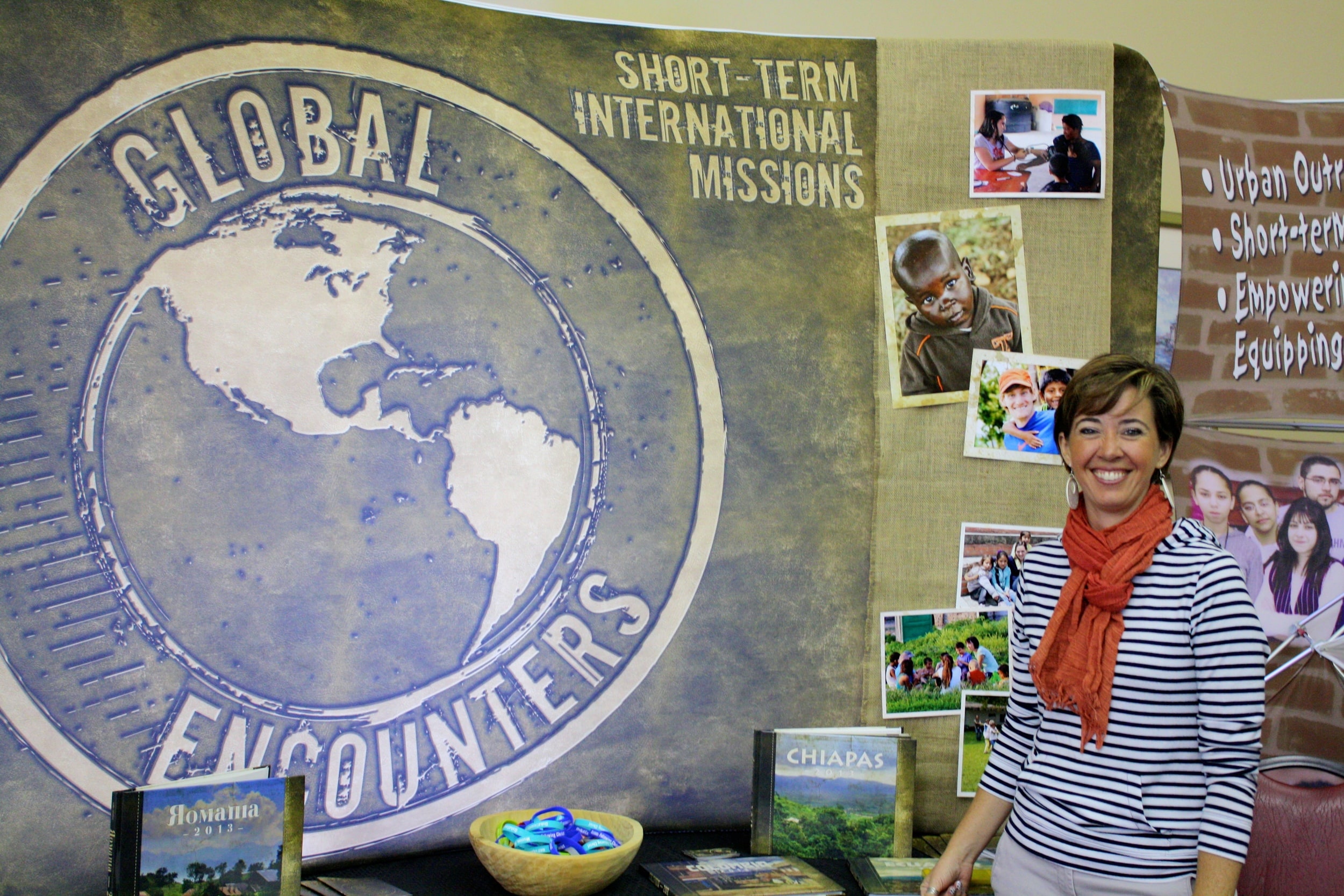  A missionary proudly stands next to her display during NGU's global missions week September 8-10. 