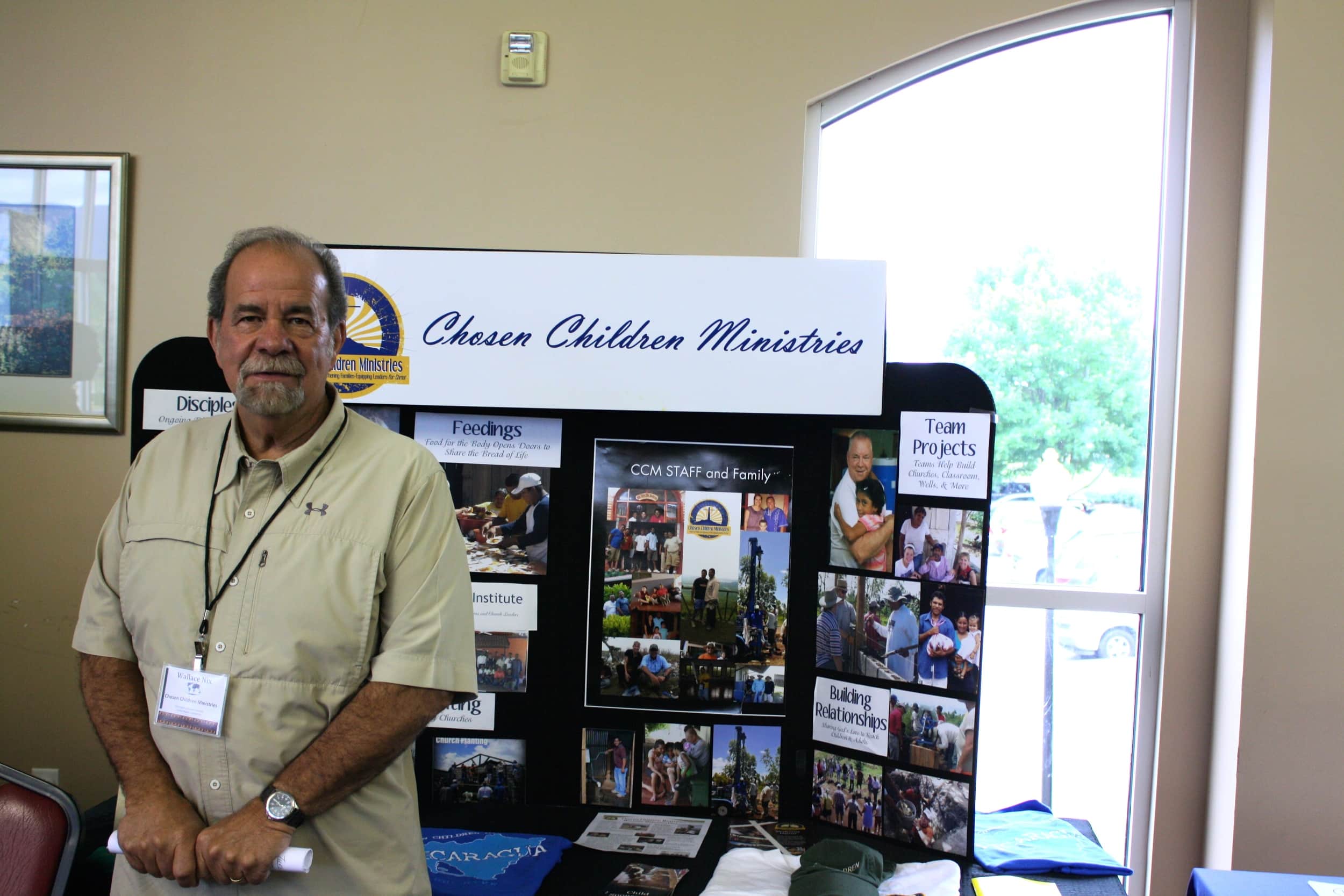  A missionary stands with his display in the cafeteria for NGU's Global Missions Week. 