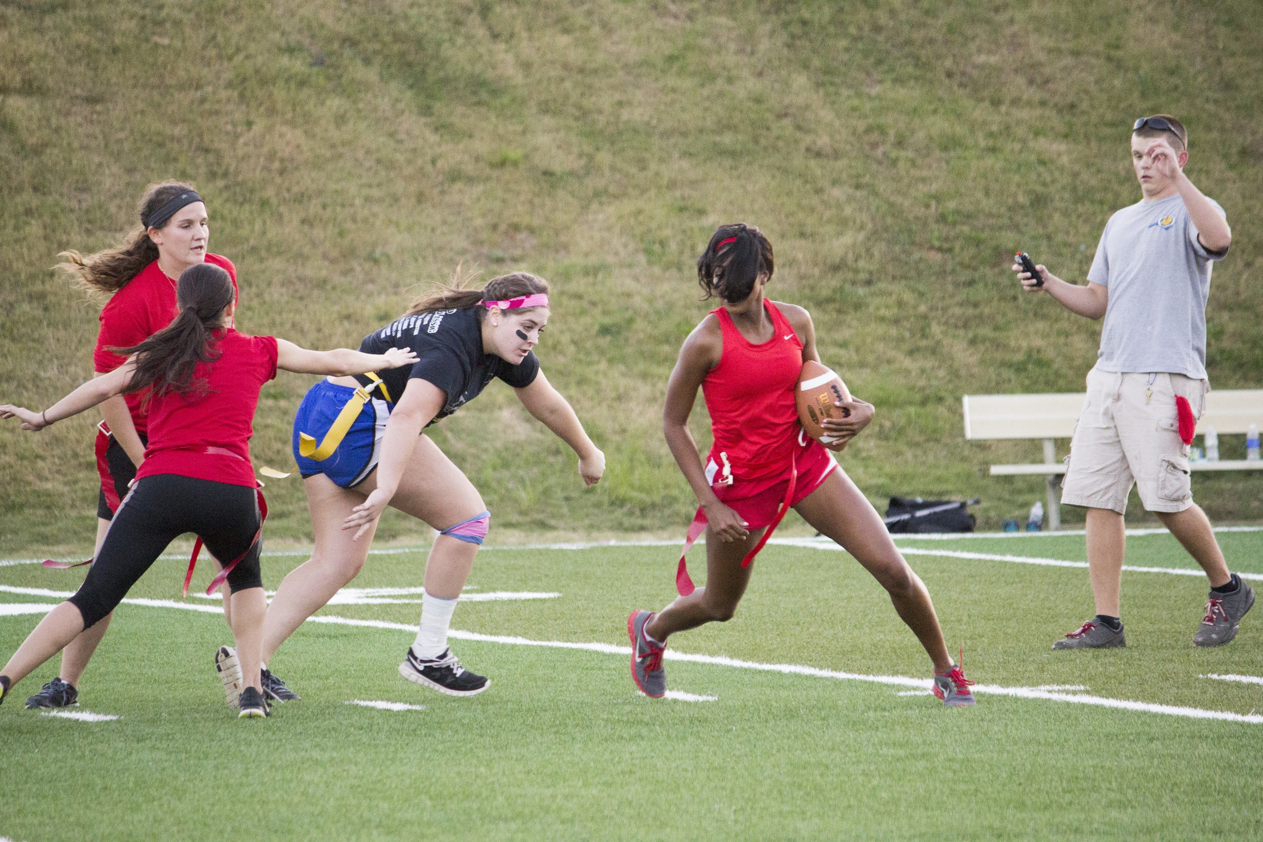  Senior Jackia Whetstone makes a running play to her left to avoid the oncoming junior player Kayla Samoros. 