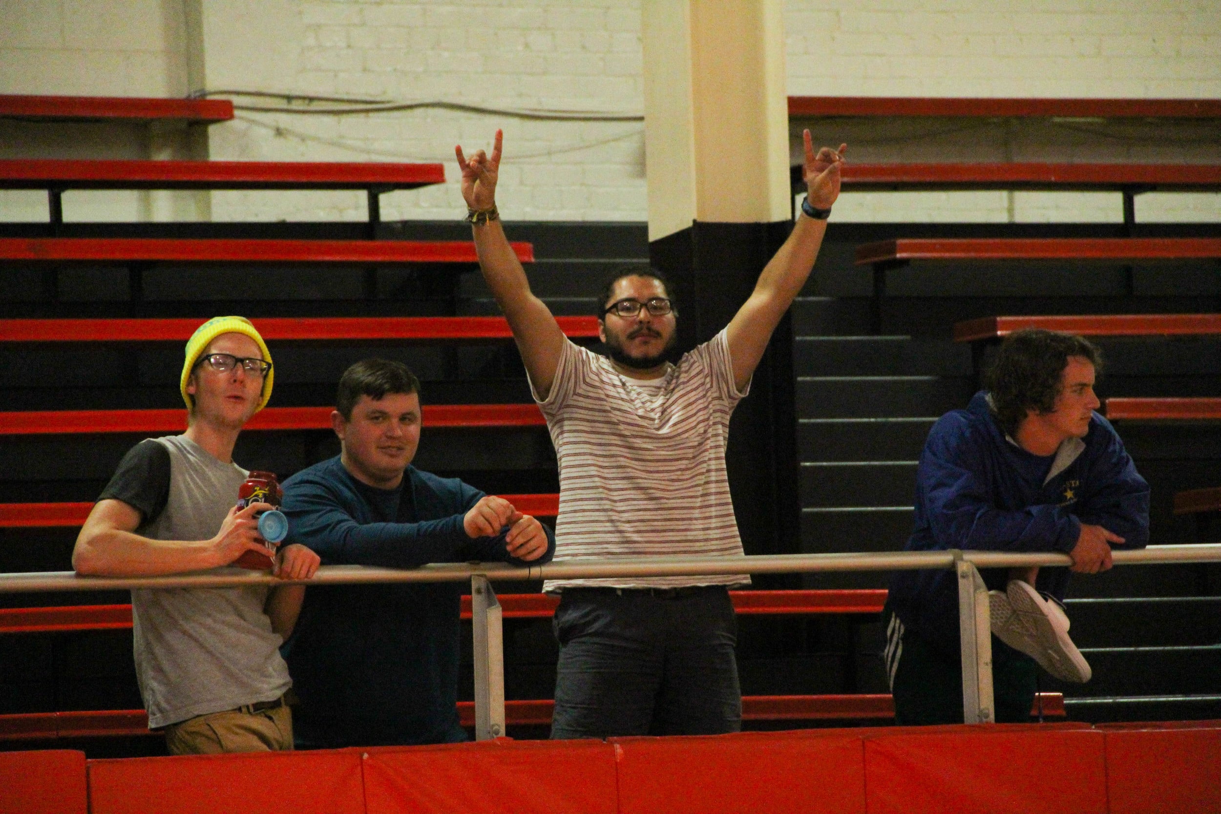 Rico Areiza, John Luke Griffith, and other students cheer for the players. 