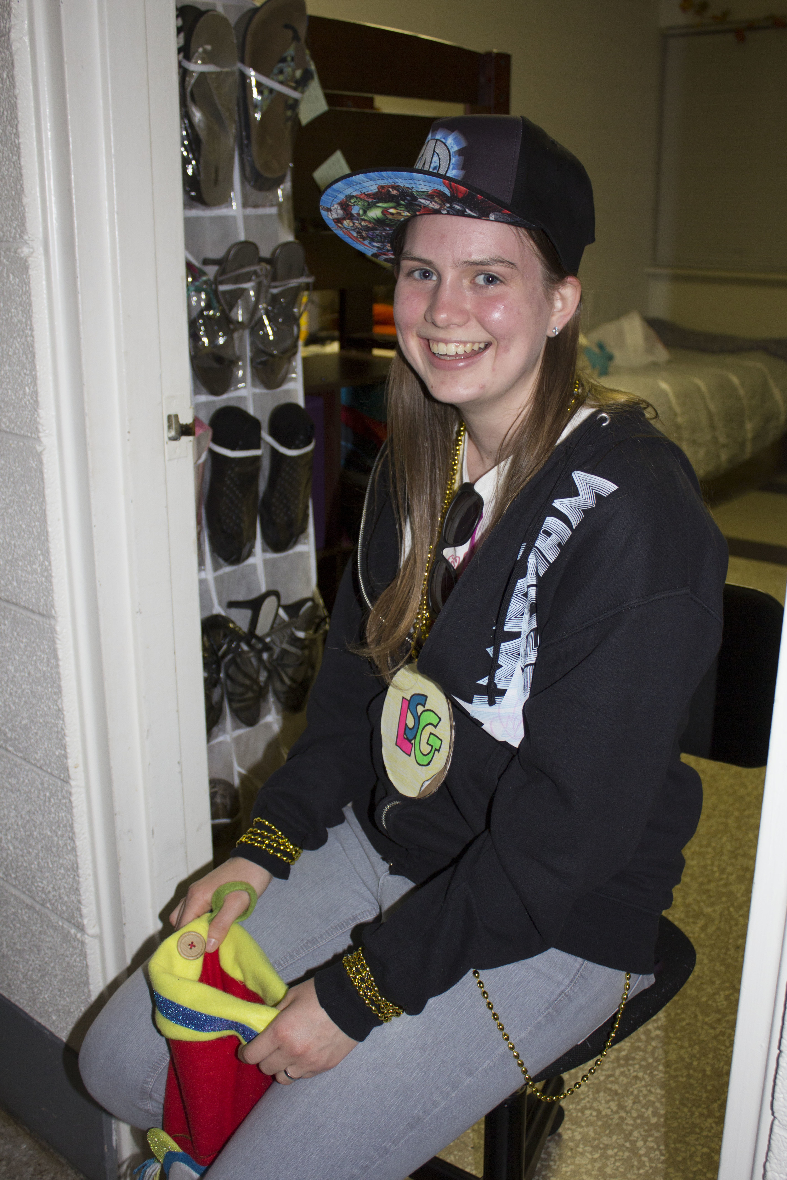 Sophomore Sarah Garrett, dressed as a gangster, holds her stocking full of candy to hand out to children passing by. 