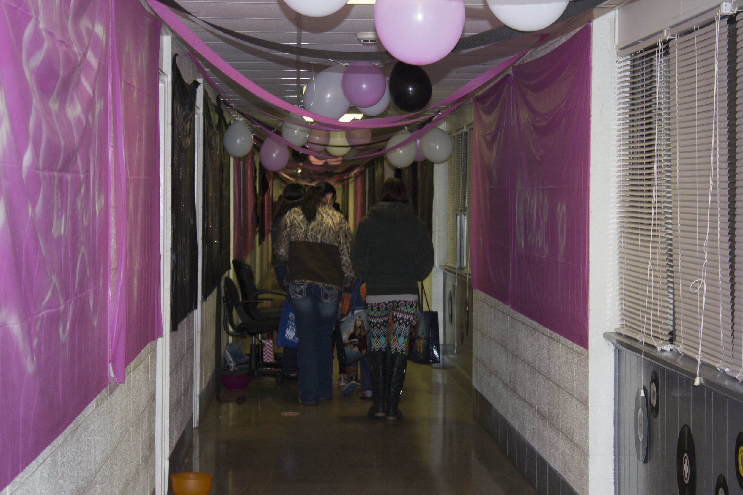  Some kids and their moms walk through bottom Simpson, decorated with a Grease theme.&nbsp; 