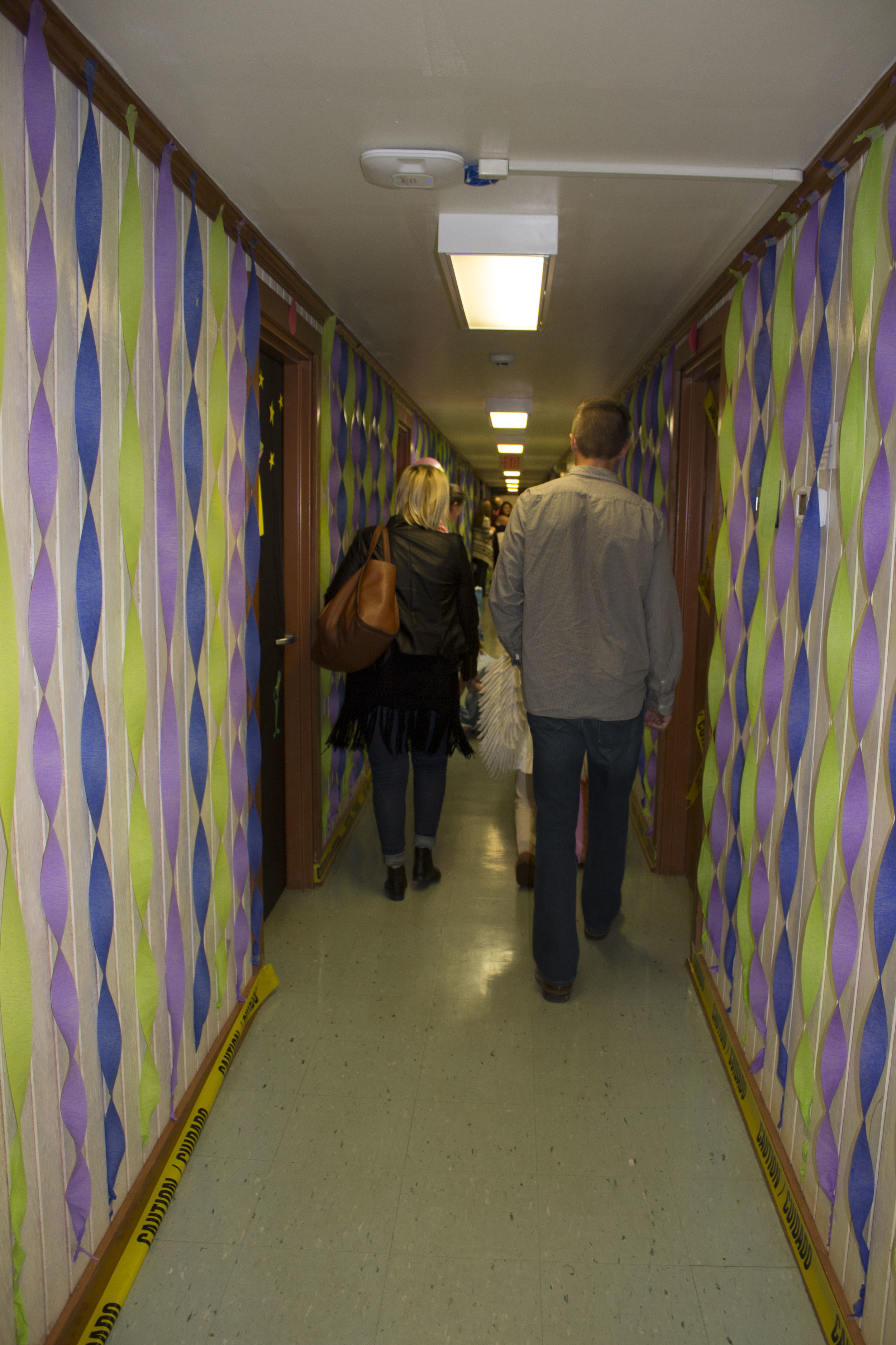  Parents walk down Emery's Monsters Inc themed dorm with their kids.&nbsp; 