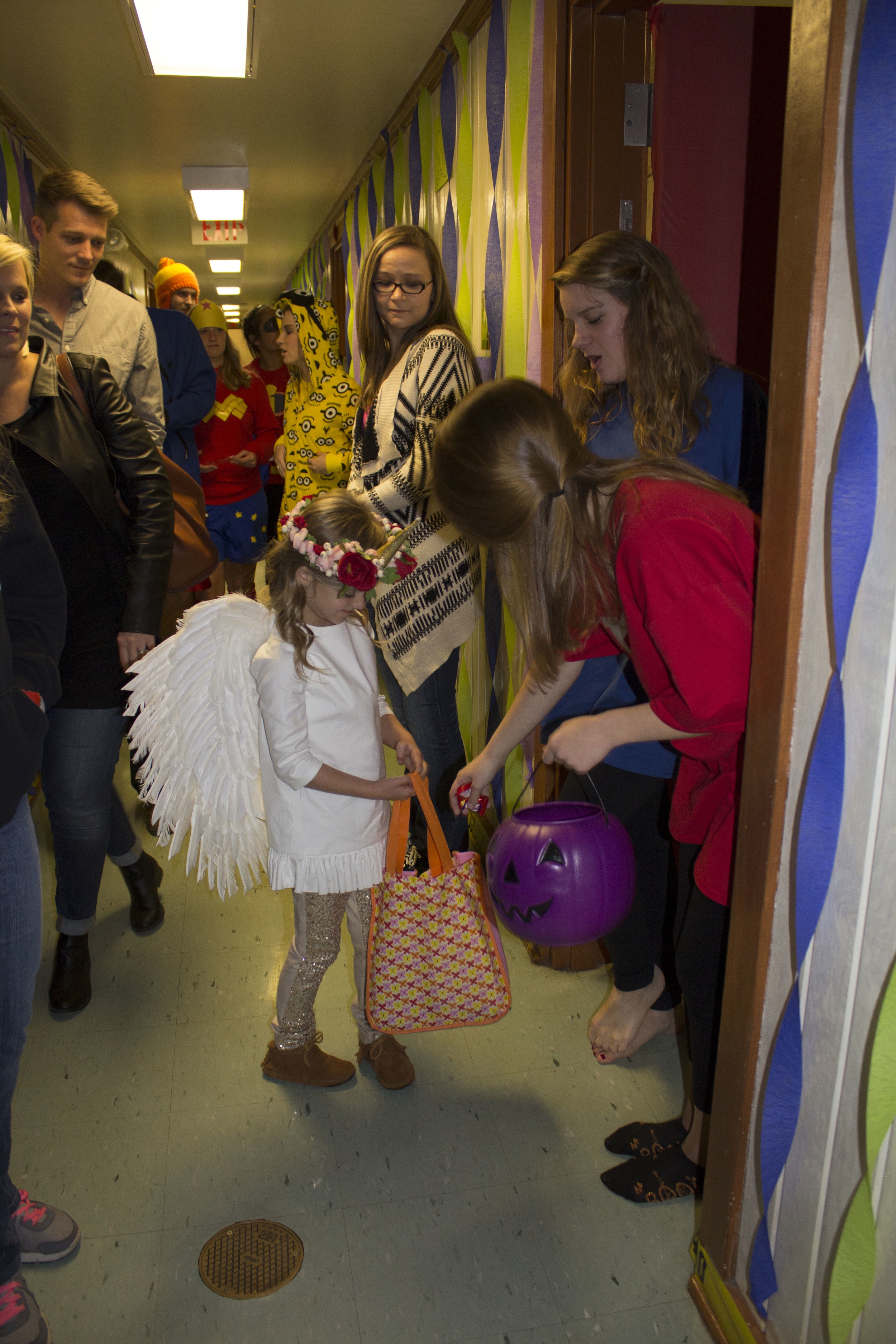  Sophomores Sarah Wells and Amy Coleman hand out candy to the kids passing down their hall.&nbsp; 