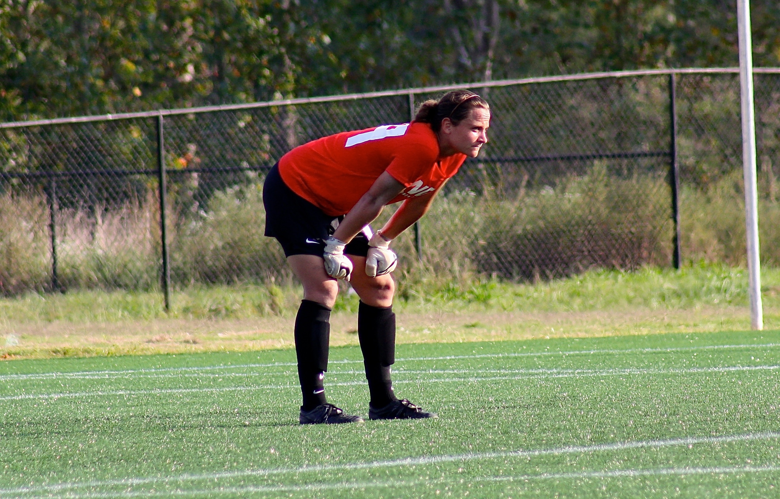  #99, Katie Tate, intently gazes onto the field. 