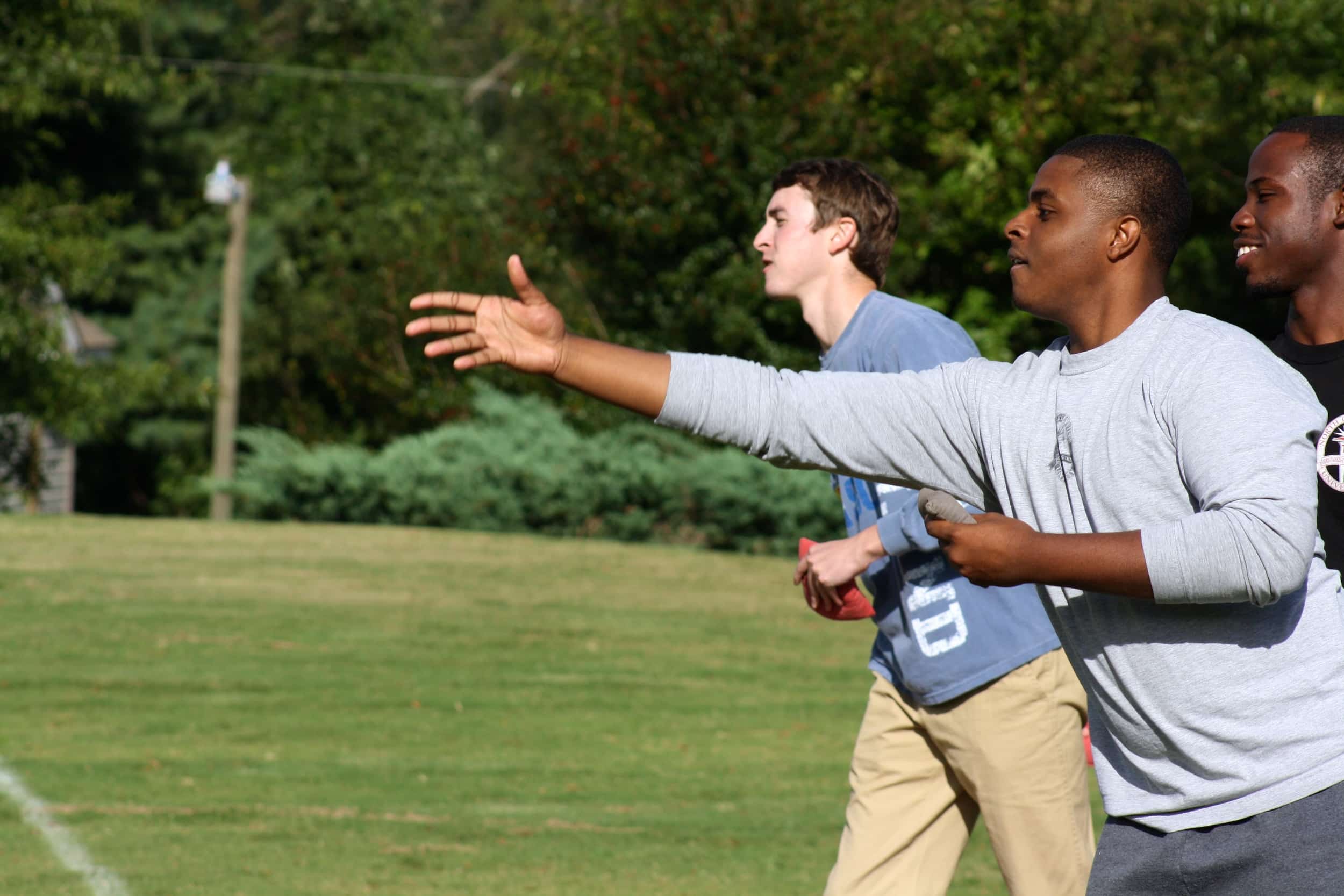  A student warms up for a round of corn-hole. 