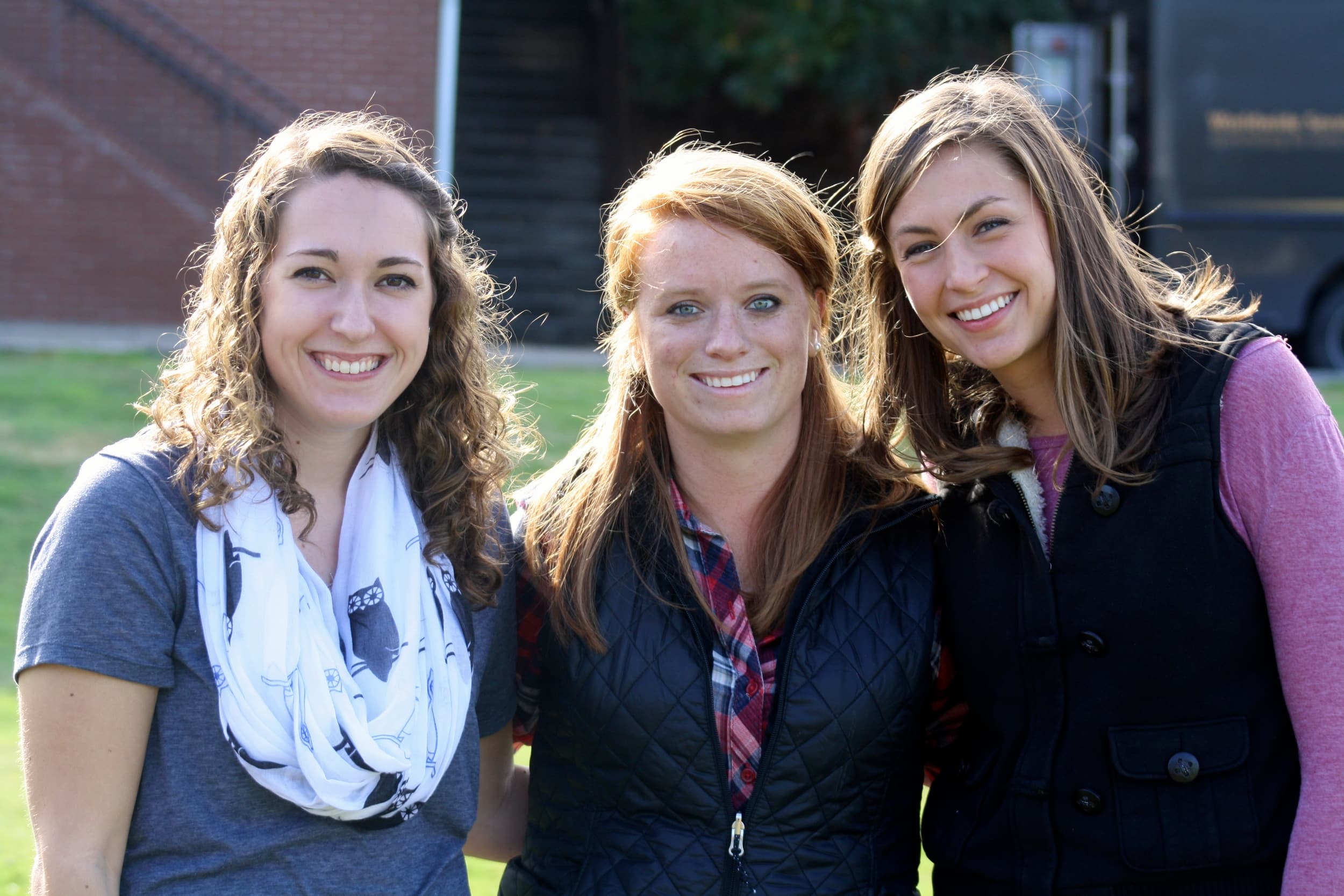  Friends gather together to observe the corn-hole tournament. 