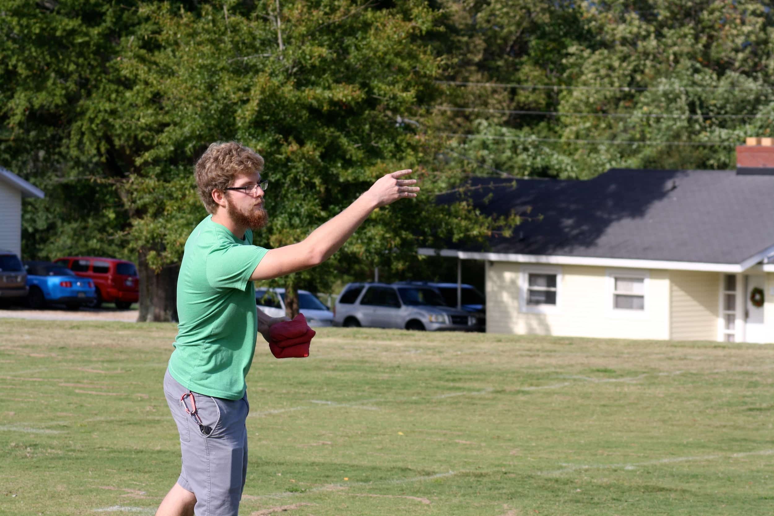  A student participates in the corn-hole tournament. 