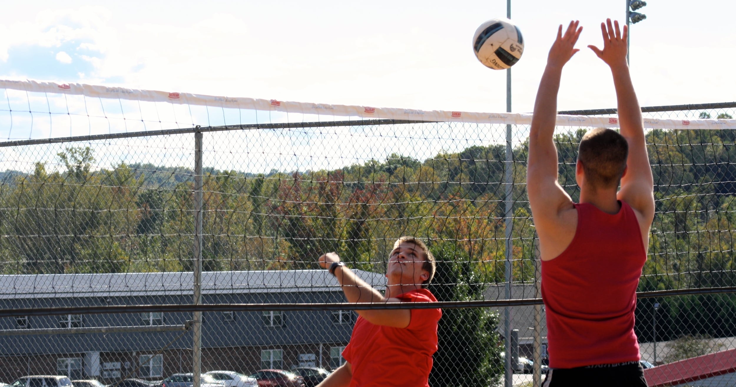  A student sends the ball over the net. 