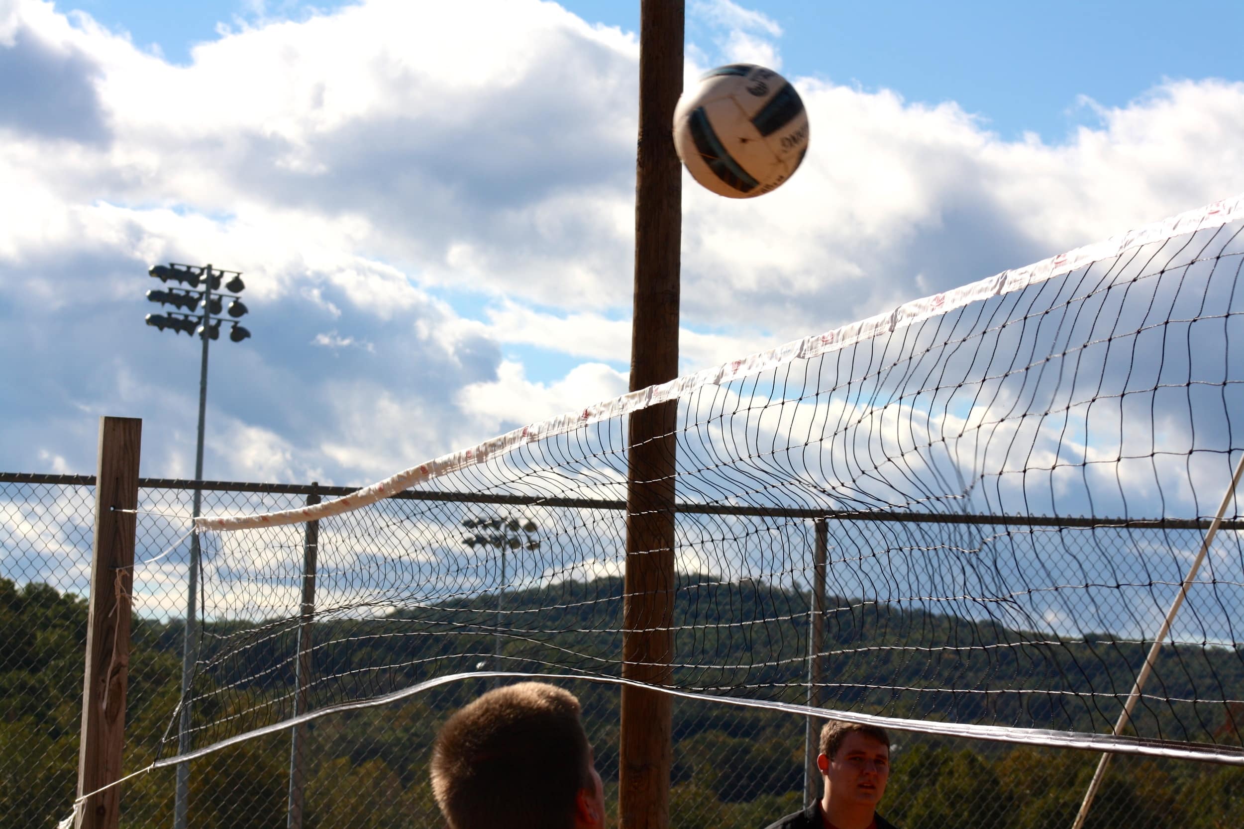  Students wait to make their move after the ball hits the net. 