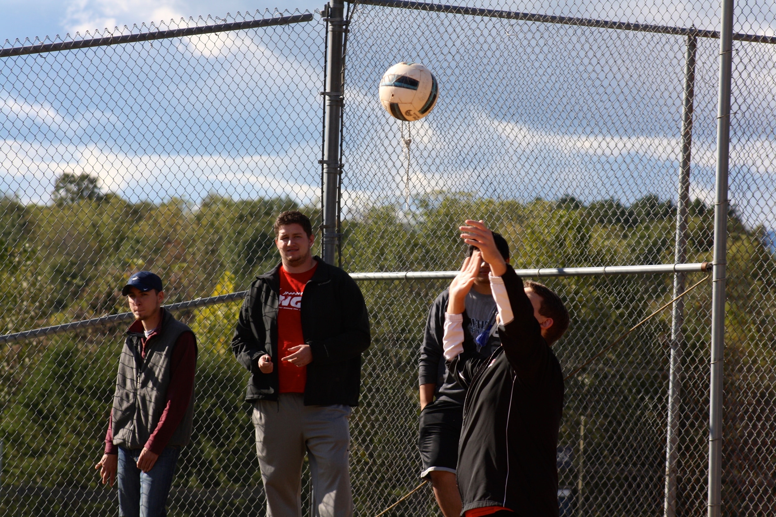  A student serves the ball by tossing it into the air. 