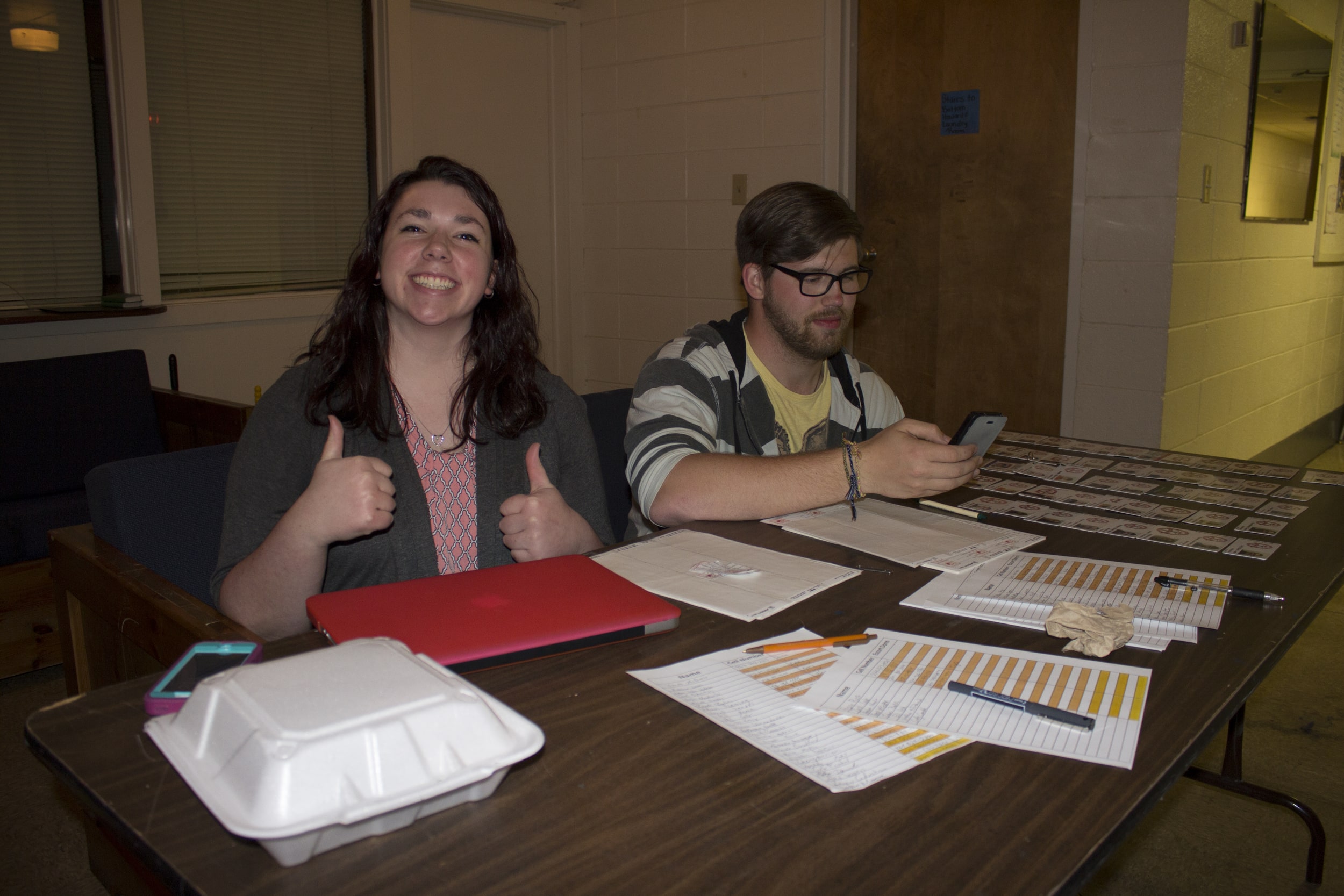  Sophomore&nbsp;Abigail Tinker and Senior Dusty Kennon run one of the check in booths for open dorms during open dorms. 