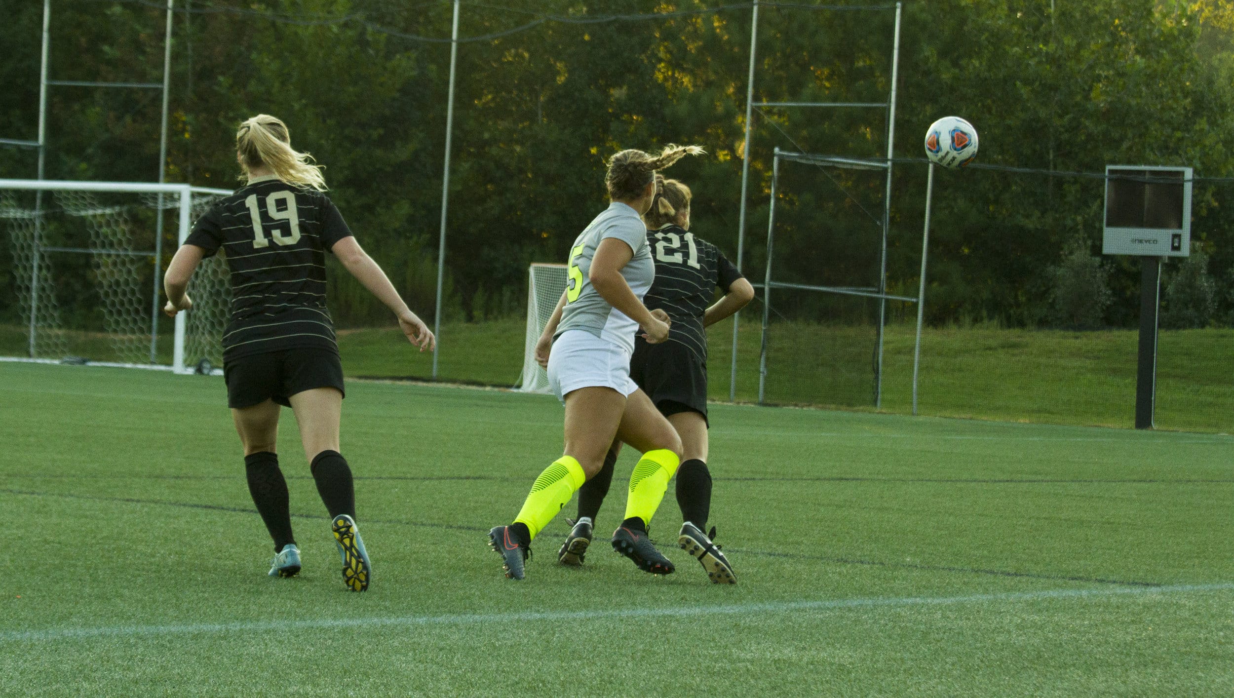  Freshman Karly Denaburg jumps and positions herself over her opponent to header the ball downfield in attempts to get closer to the goal.&nbsp; 