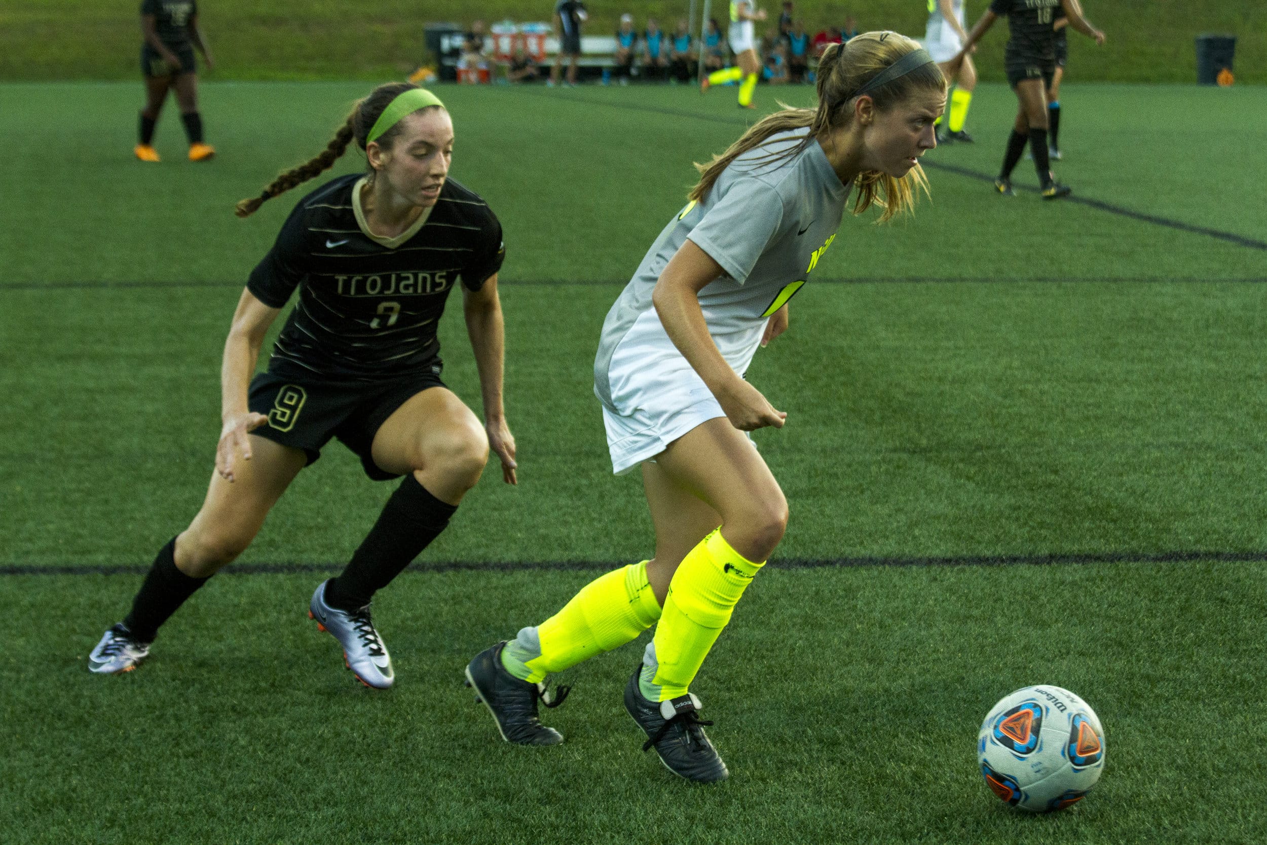  Britt looks down the line with determination in her eyes, trying to pass off the ball to a teammate before &nbsp;Trojans player 9 can steal the ball from her.&nbsp; 