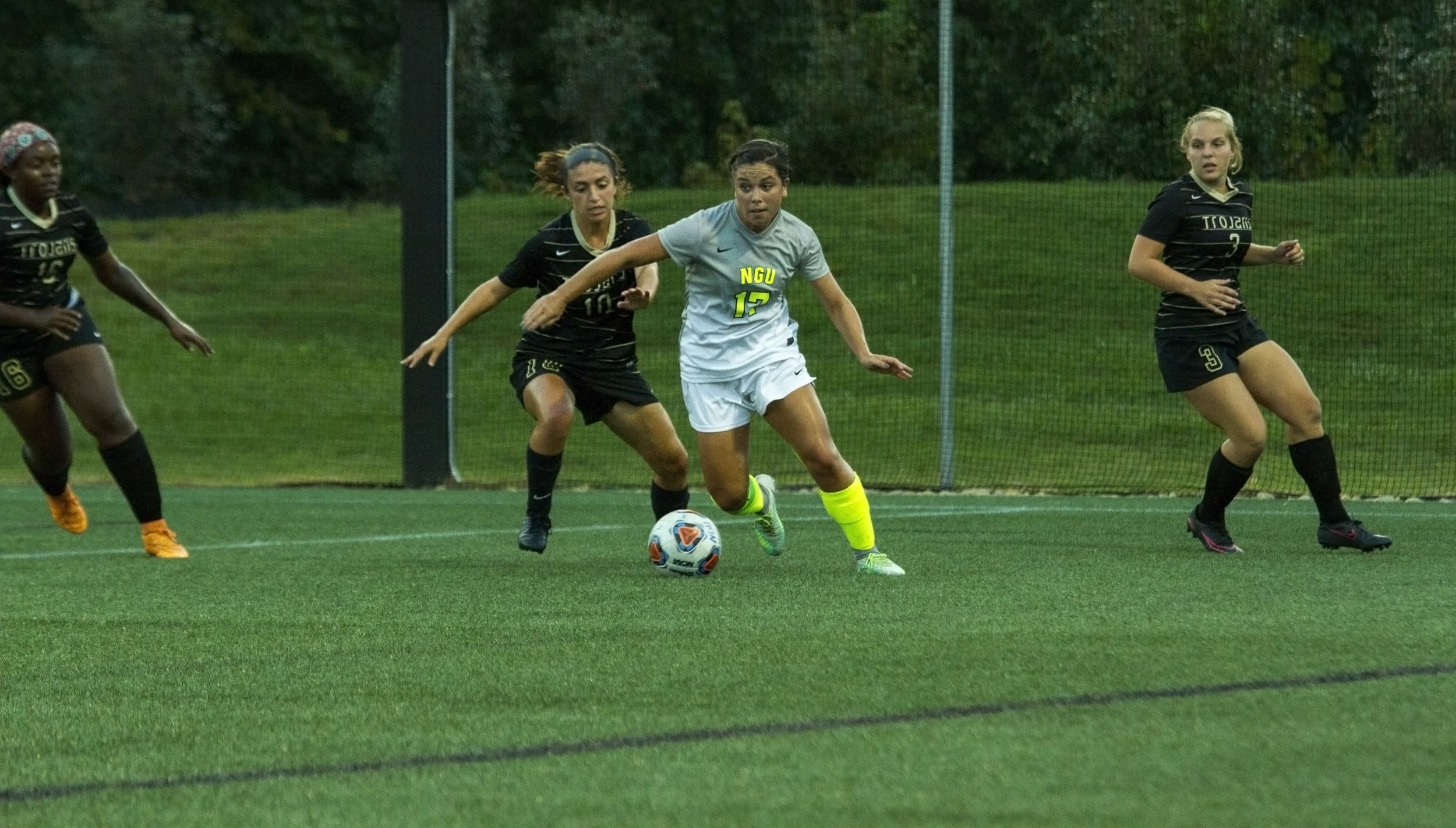  Robertson pushes past several Trojans players to bring the ball back to center field to try and turn to make a shot on goal.&nbsp; 