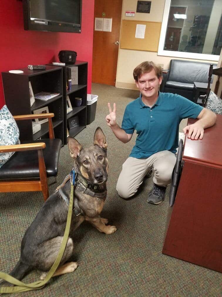 Vision Radio Station Manager Connor Boulet with K9 Barrett.