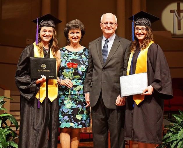Nicole and Rachel with their parents at their high school graduation