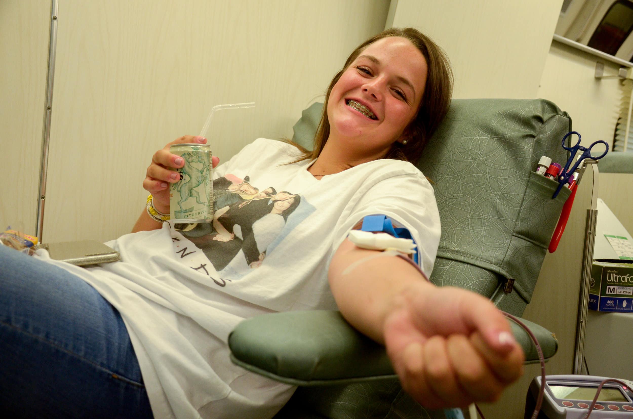 Freshma, Jennifer Garrett sips on her soda while giving blood to ensure that everything goes smoothly. Garrett has given blood twice and says she does it because it is for a good cause.