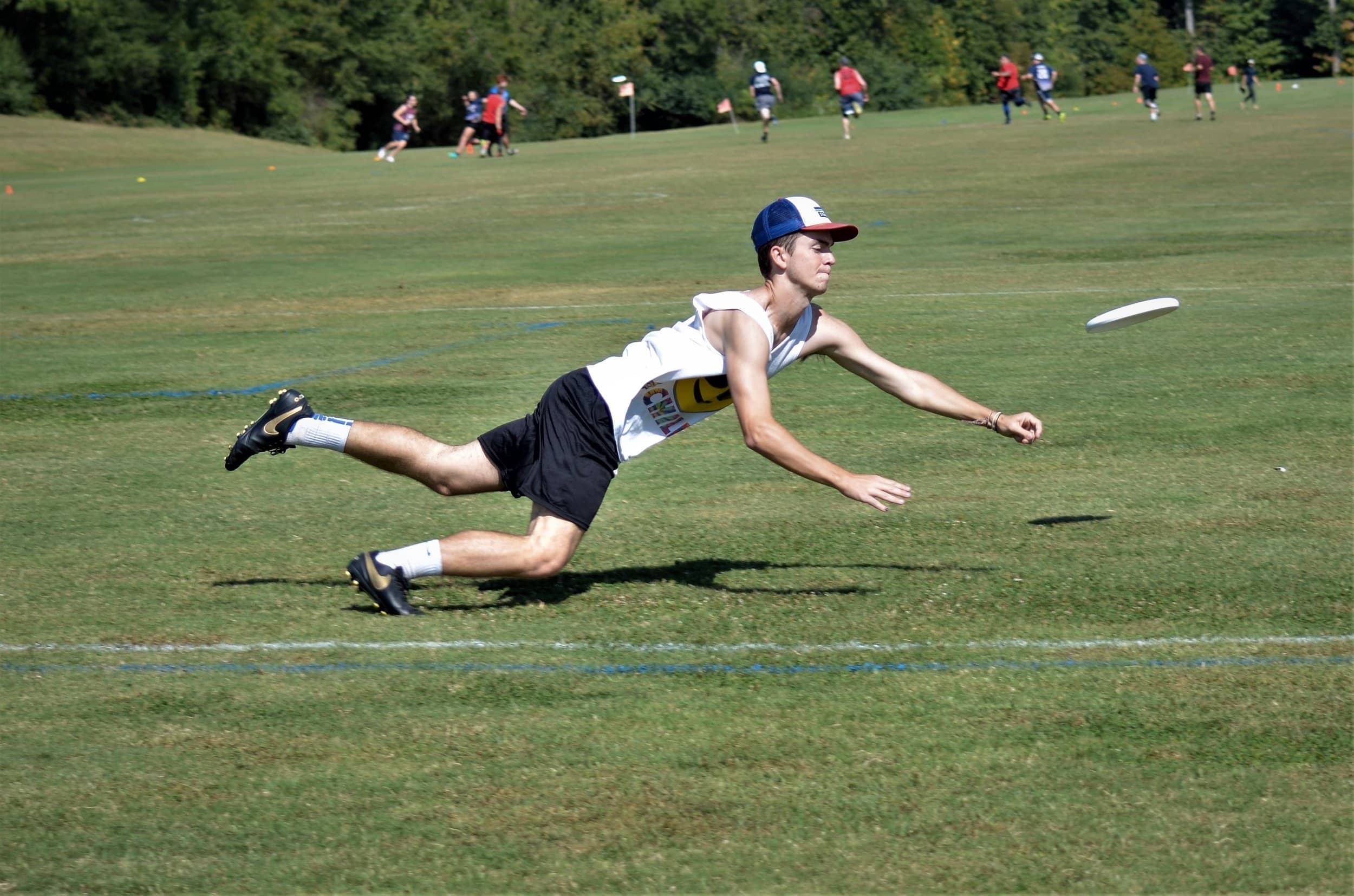 Andrew Guy lays out for a disc in the endzone.