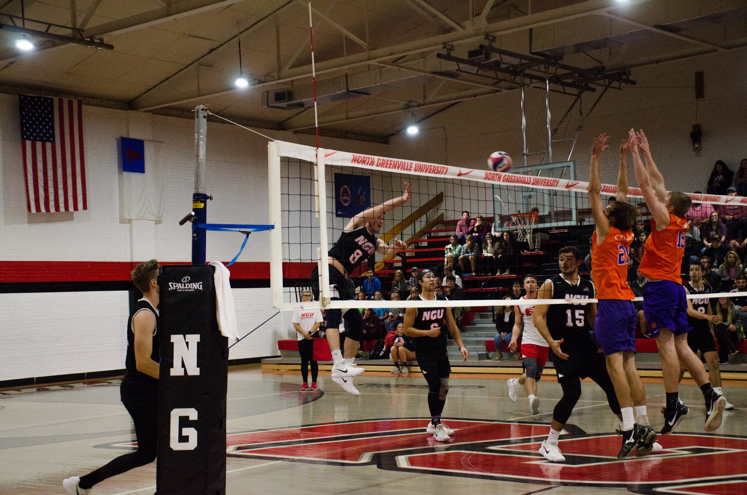 Gilbert spikes the ball to the other side of the net to get past Clemson's defenders.