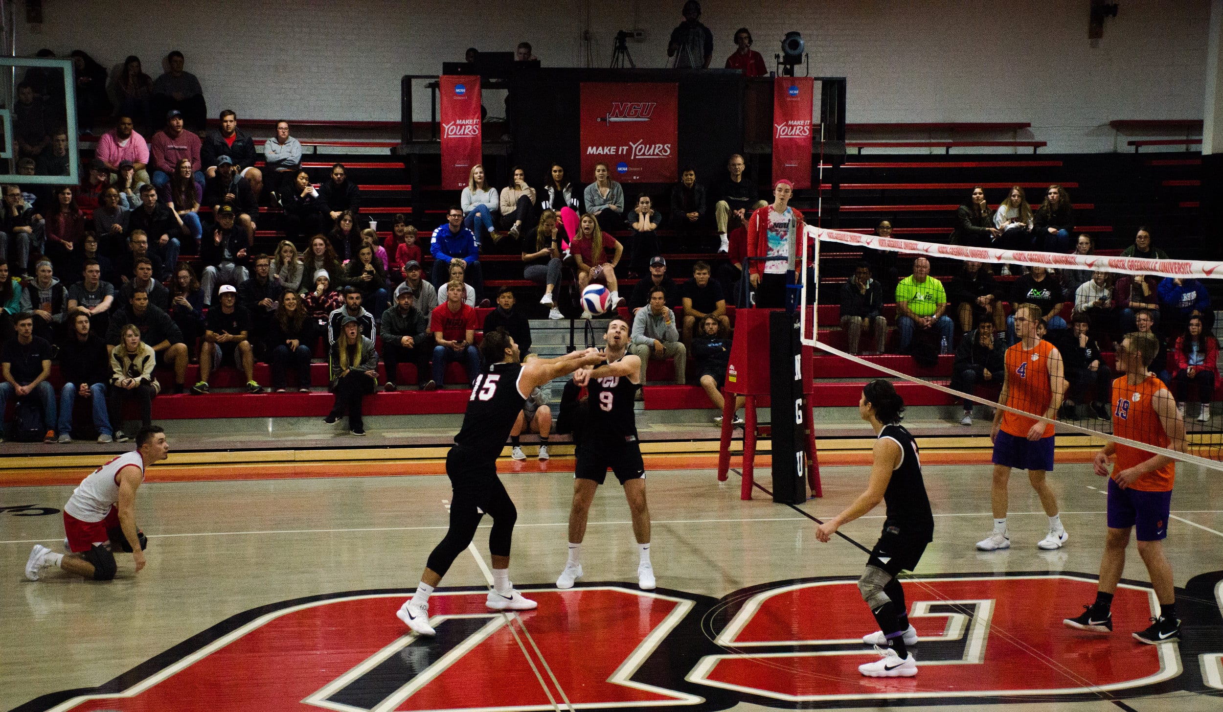 Matthew McManaway (senior) and Grayson Lawrence (junior) work as a team to get the ball over the net.