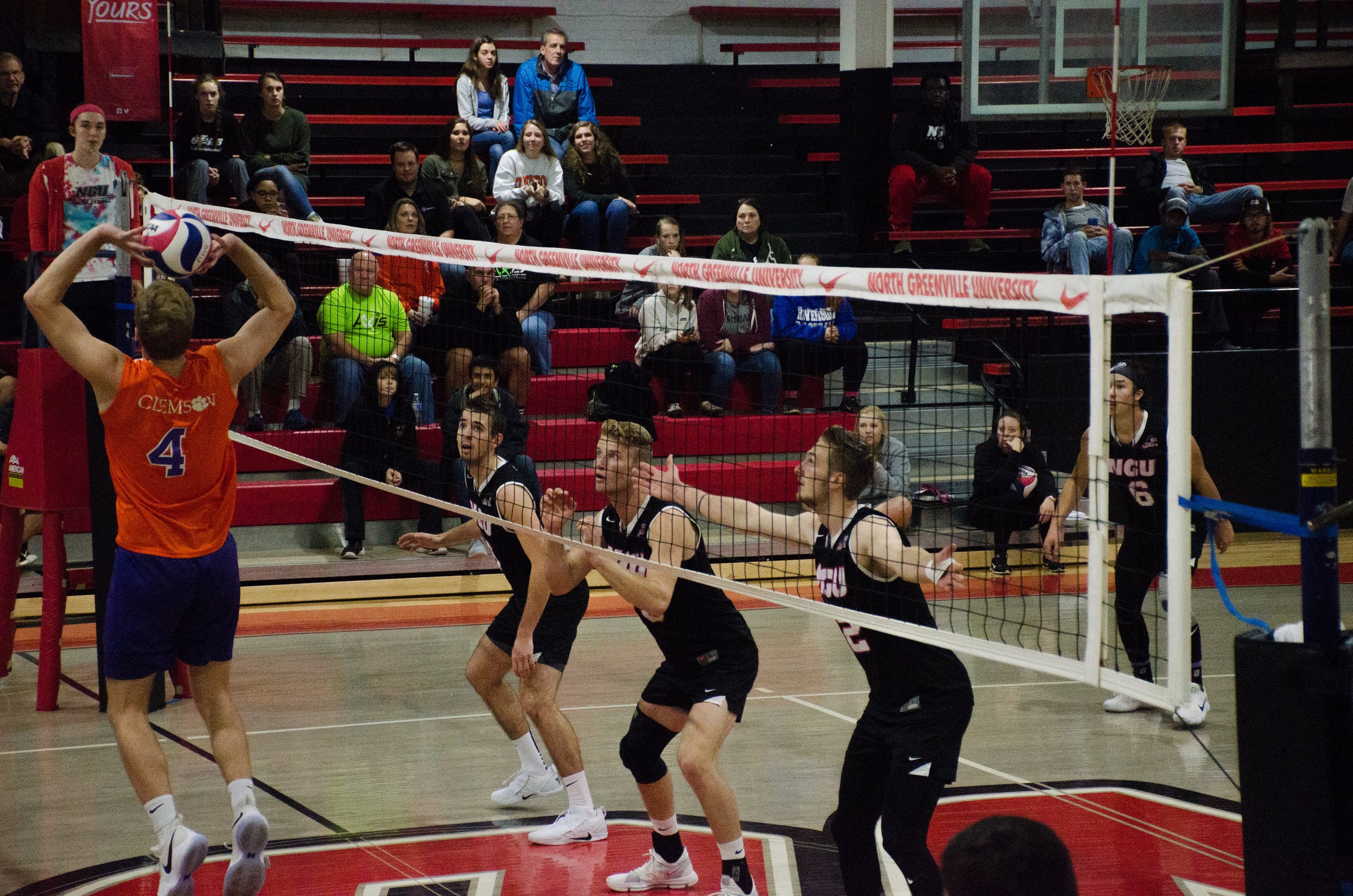 Grayson Lawrence (junior),&nbsp;Ben Hamsho (sophomore) and Aaron Campbell (junior) get ready to block a spike from Clemson.