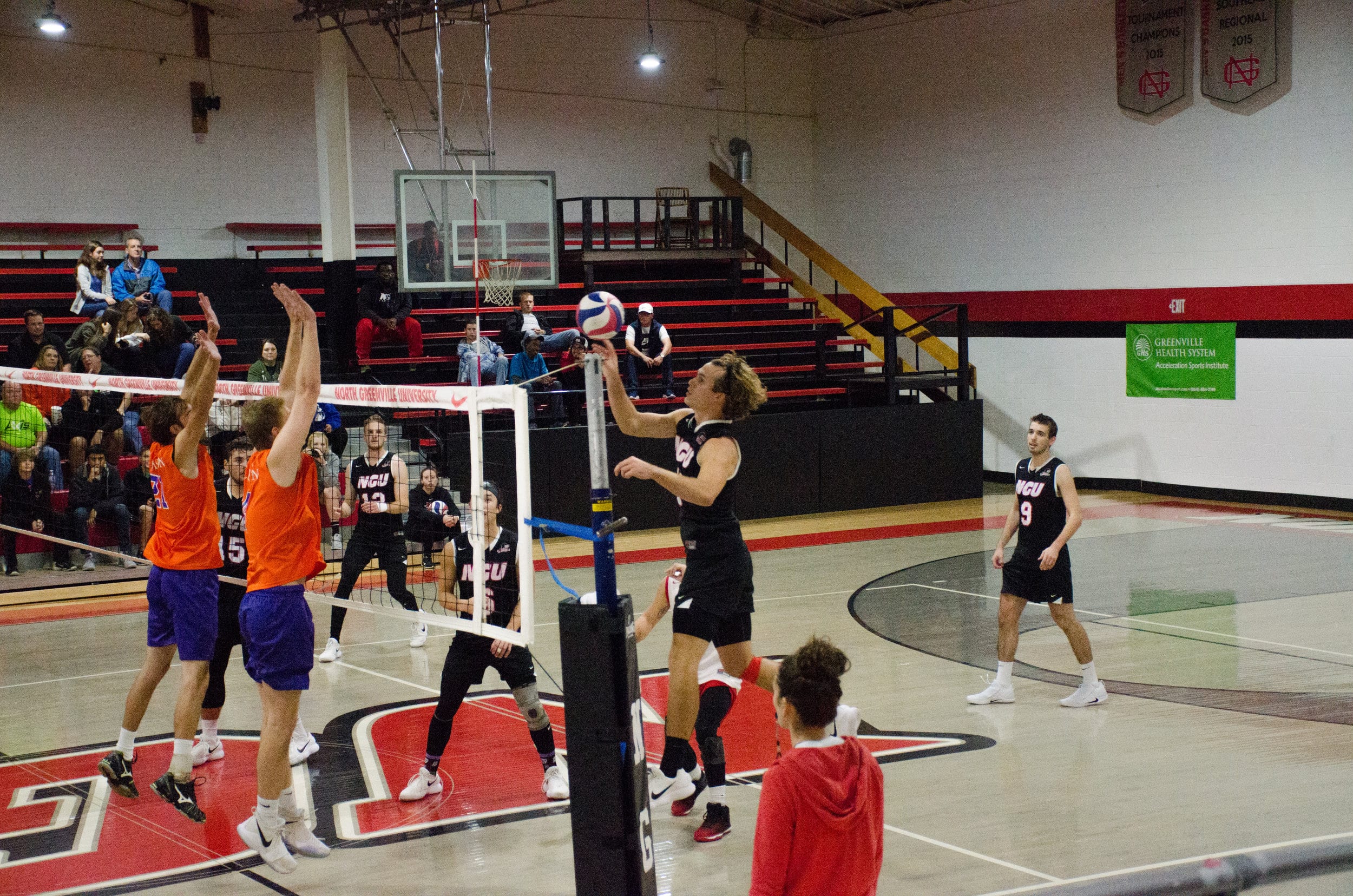 Kyle Brandt, junior, easily taps the ball over the net past the defenders.