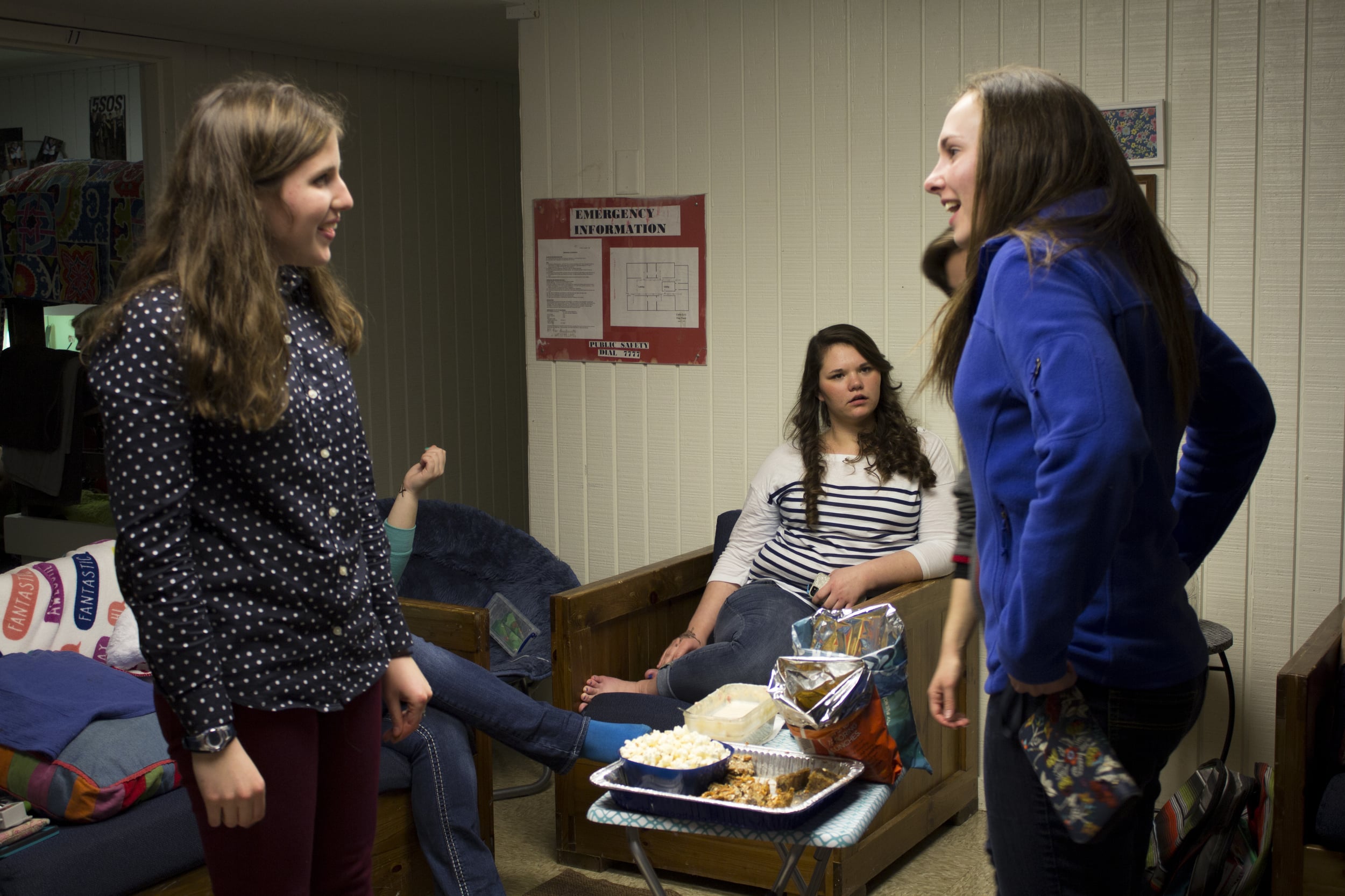  Often during open dorms, girls enjoy preparing food to eat, always making the party that much more fun. Sophomore Meg Darby chats with junior Rachel Alley around the chips and sweets table in the middle of the common room.&nbsp; 