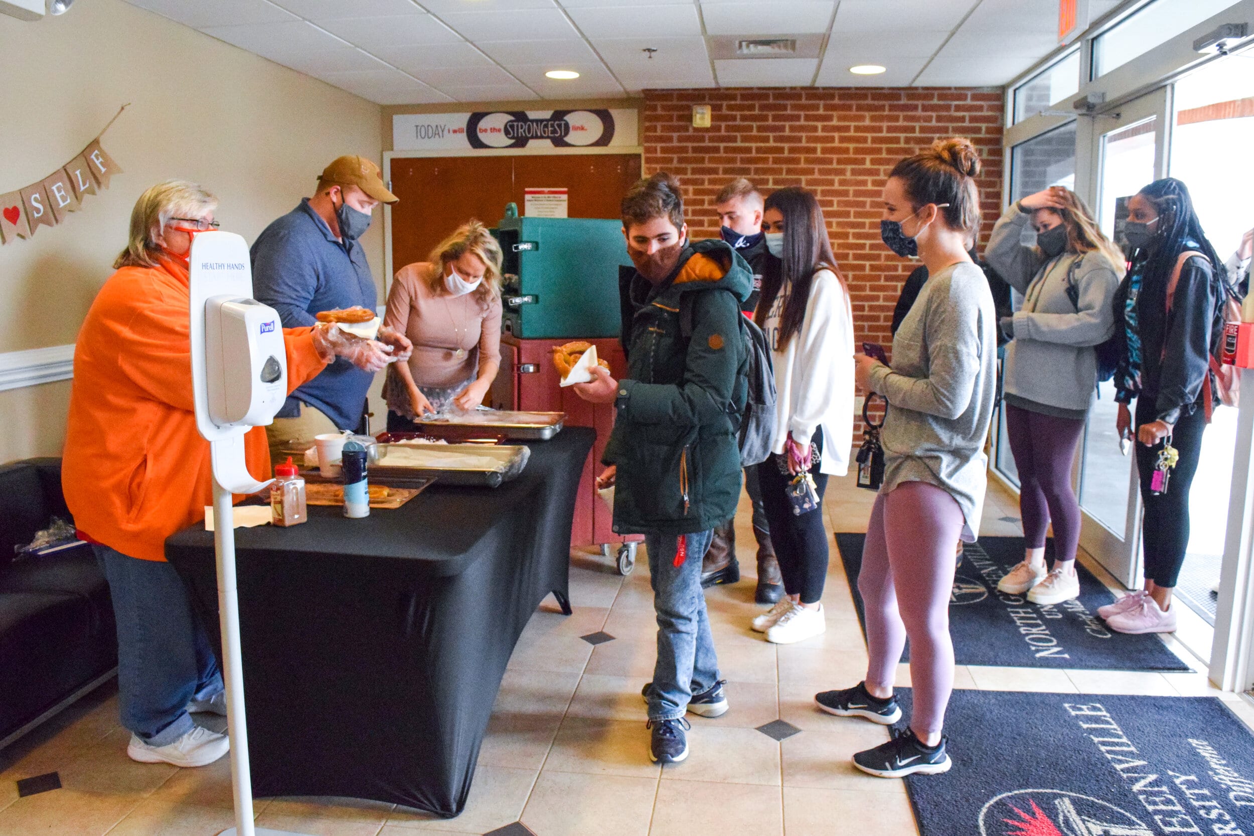 Members of Student Life hand out pretzels to NGU students.
