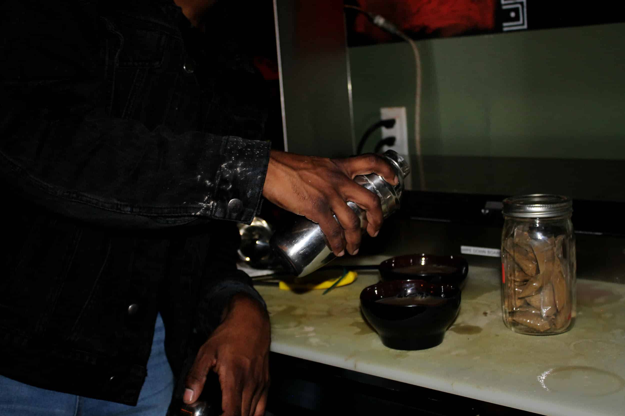 Marcus pouring a shell of traditional Kava, the main drink you can get at The Kava Konnection for only $5 during happy hour Tuesdays-Thursdays 5-7 p.m.