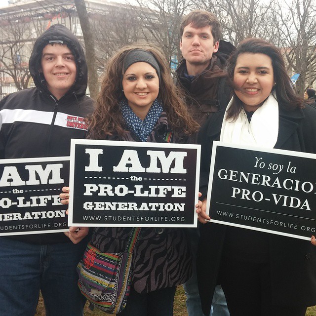 Aivarenga joins fellow NGU students in holding up her pro-life poster for the march against abortion.&nbsp;