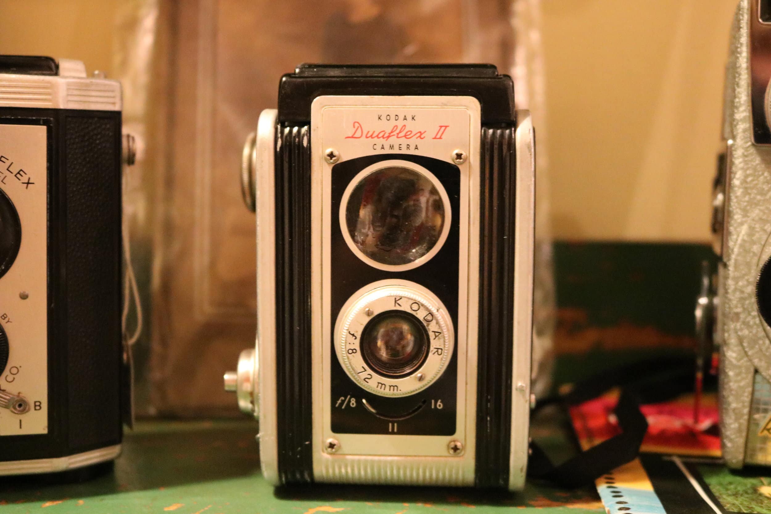 A Kodak Duaflex II camera for sale in the collection of cameras throughout the store.