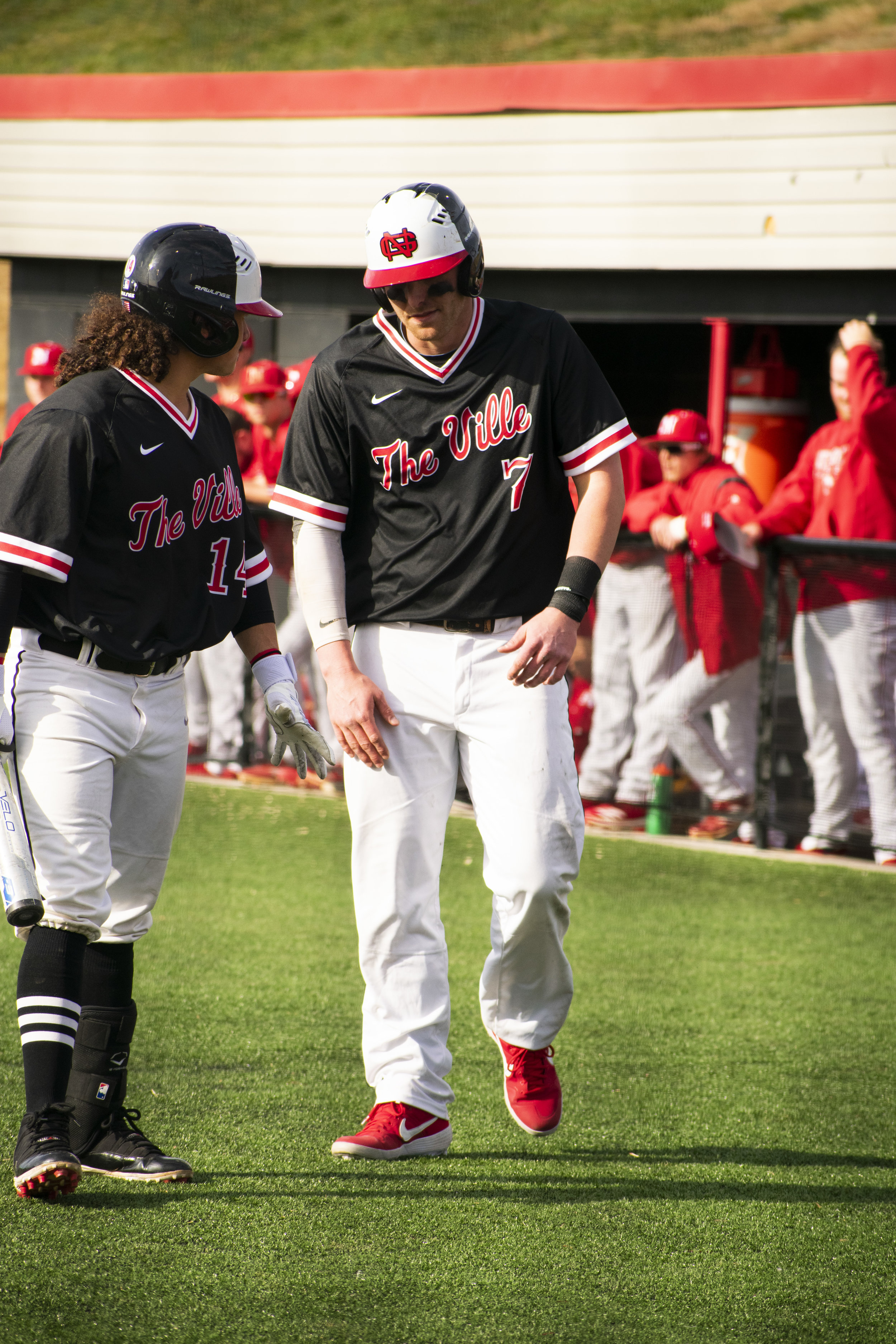 Sophomore Elvin Rosa (14) congratulates Junior Michael Neustifter (7) for just finishing running the bases, scoring points for the team.