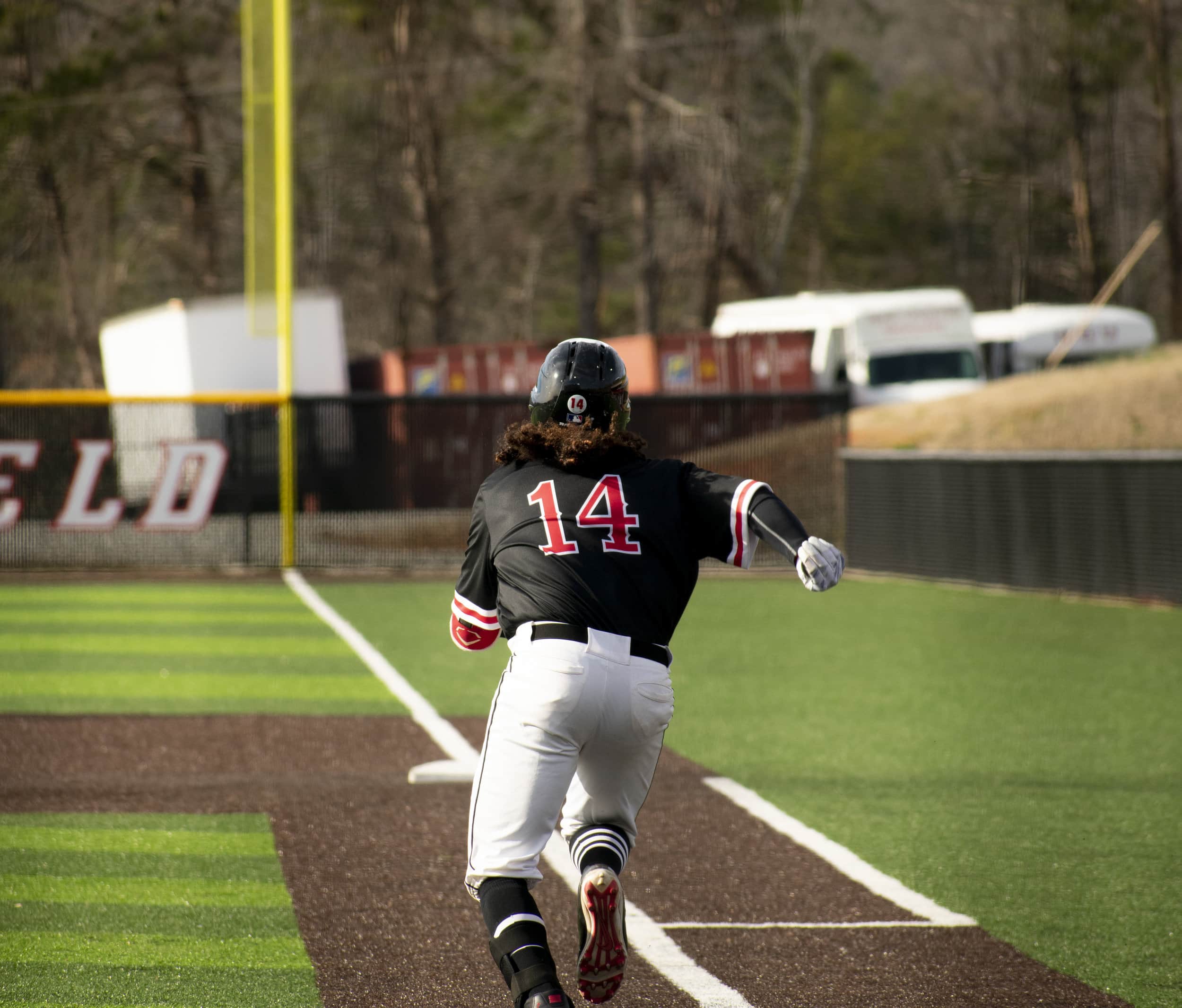 Rosa hits the ball and sprints to first base.