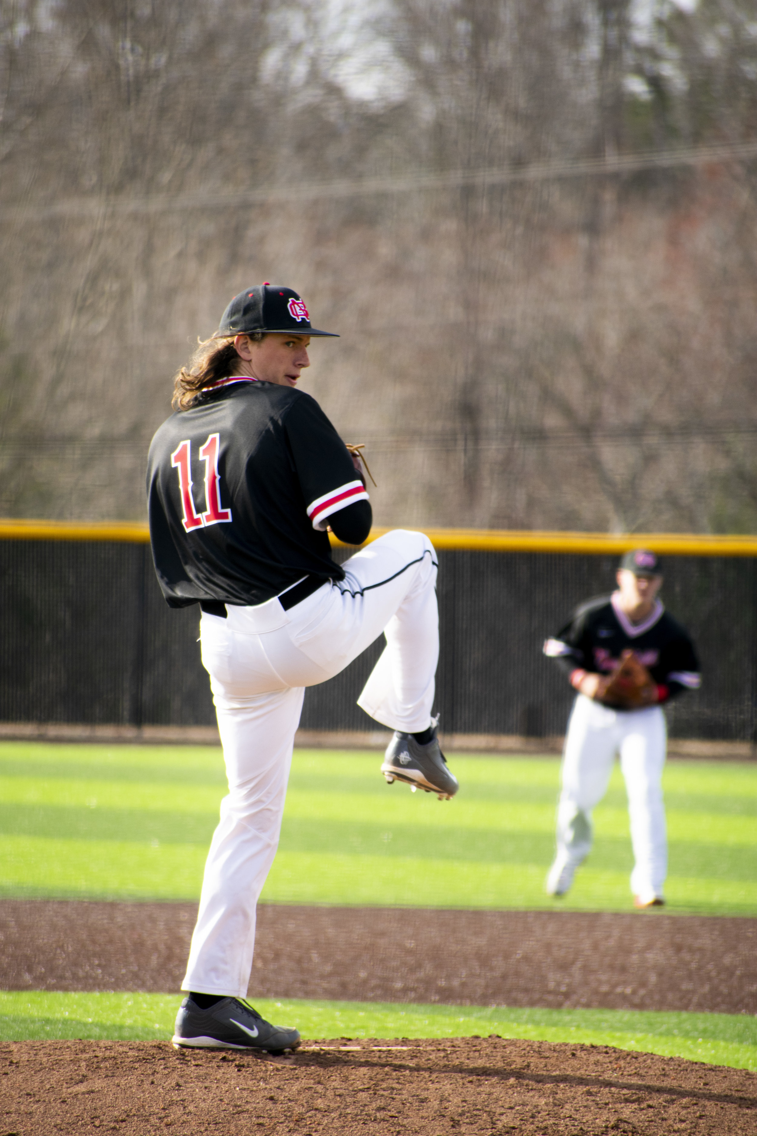 Junior Michael Giacone (11) pitches the ball.