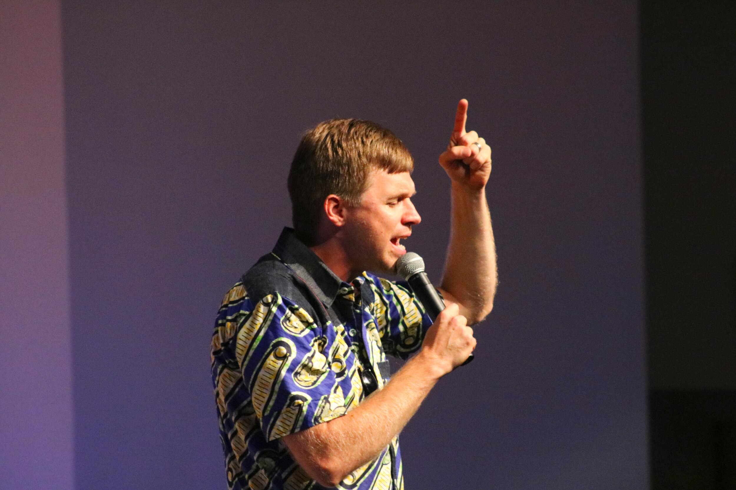 North Greenville University BCM director Joshua Gilmore prays after worship and before his guest speaker Chad Stillwell comes on stage to speak to the congregation.