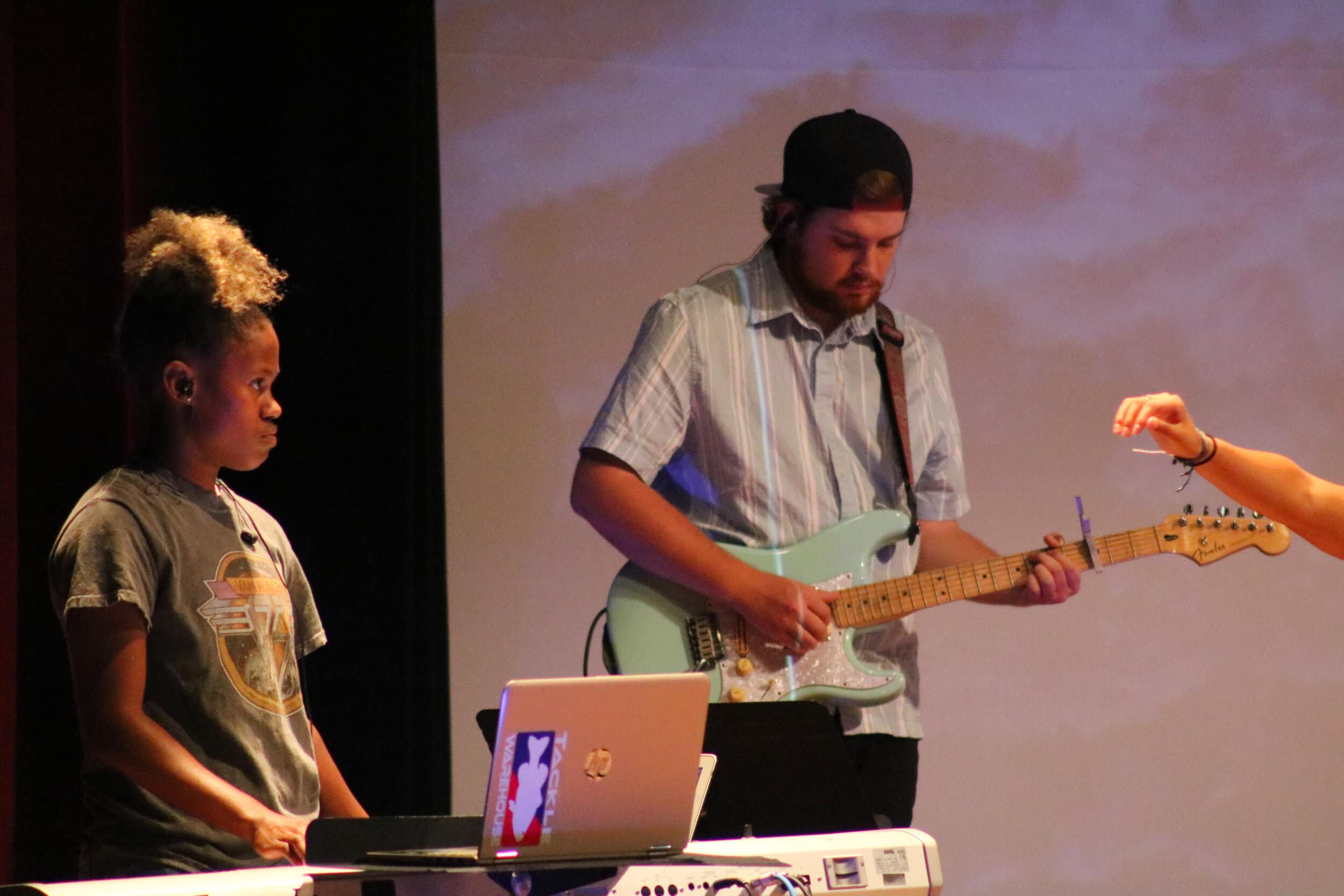 Junior Savannah Hughes (keys) looks for another cue from her band mates while junior Sawyer Evans (electric 2) focuses on his guitar.