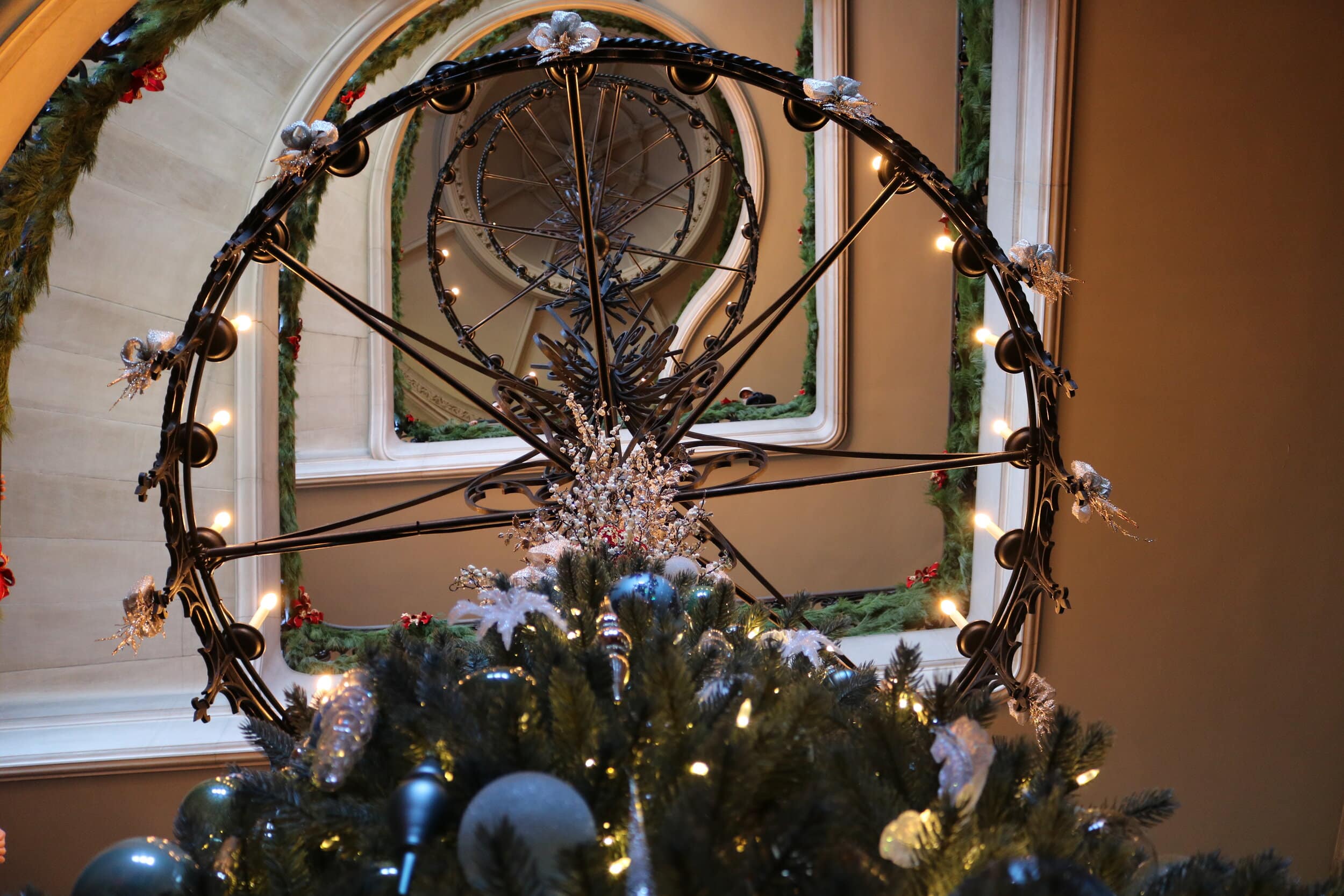 A view up the main stair case and chandelier, from the bottom of the Christmas tree on the main floor.