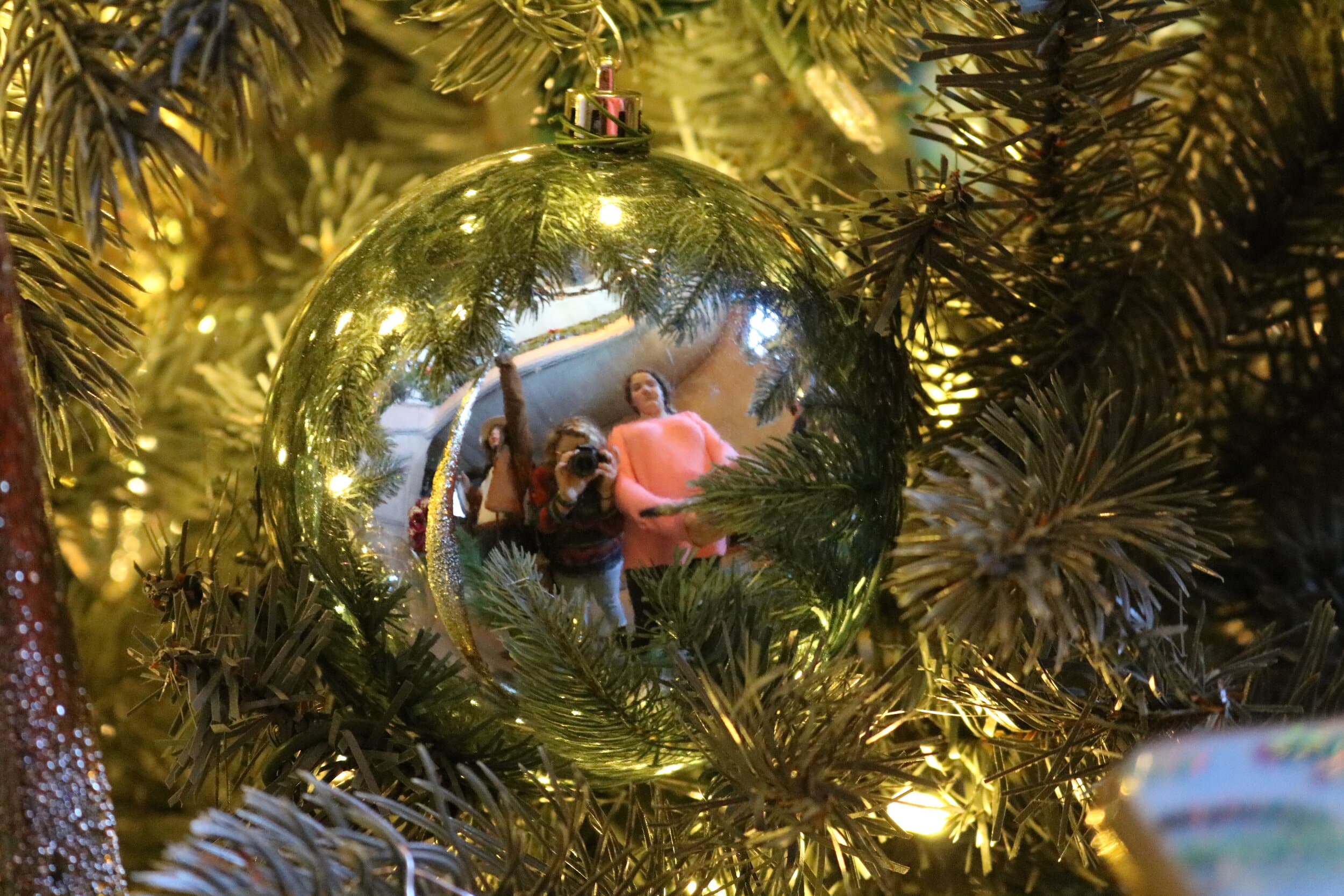 A picture of me and my friend, Beebe Griner, in a shiny ornament that was hung on the Christmas tree at the bottom of the main stair case.