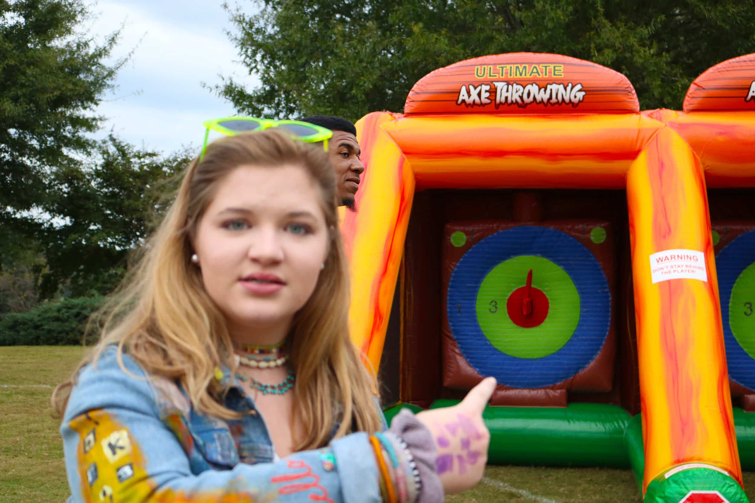 Freshman Caroline Crusco point at her bullseye at the Ultimate Are Throwing game.