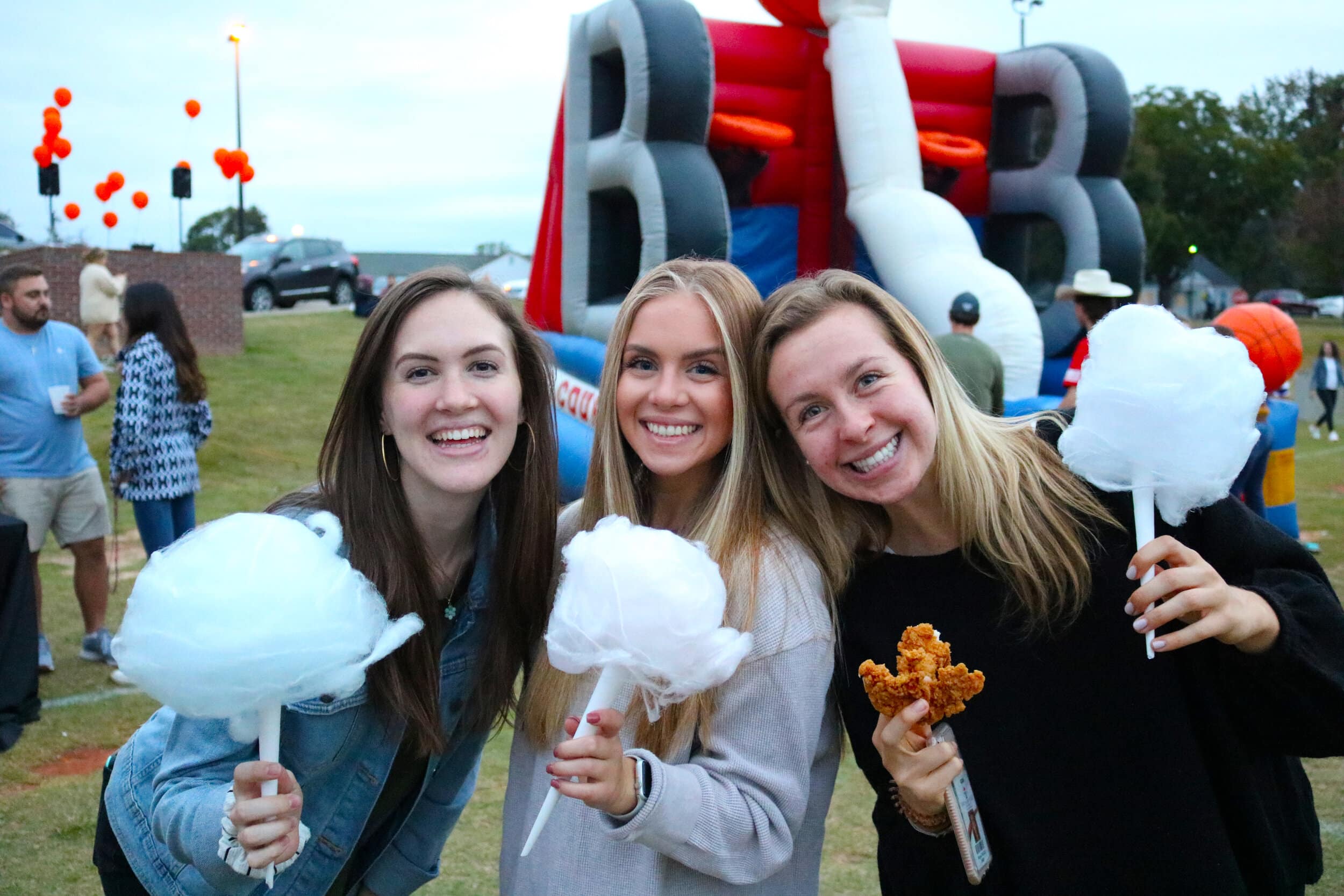 Senior Kailyn Horn and sophomores Rachel Stanley and Abby McCall get some free cotton candy (and chicken fingers) before hitting the fair.