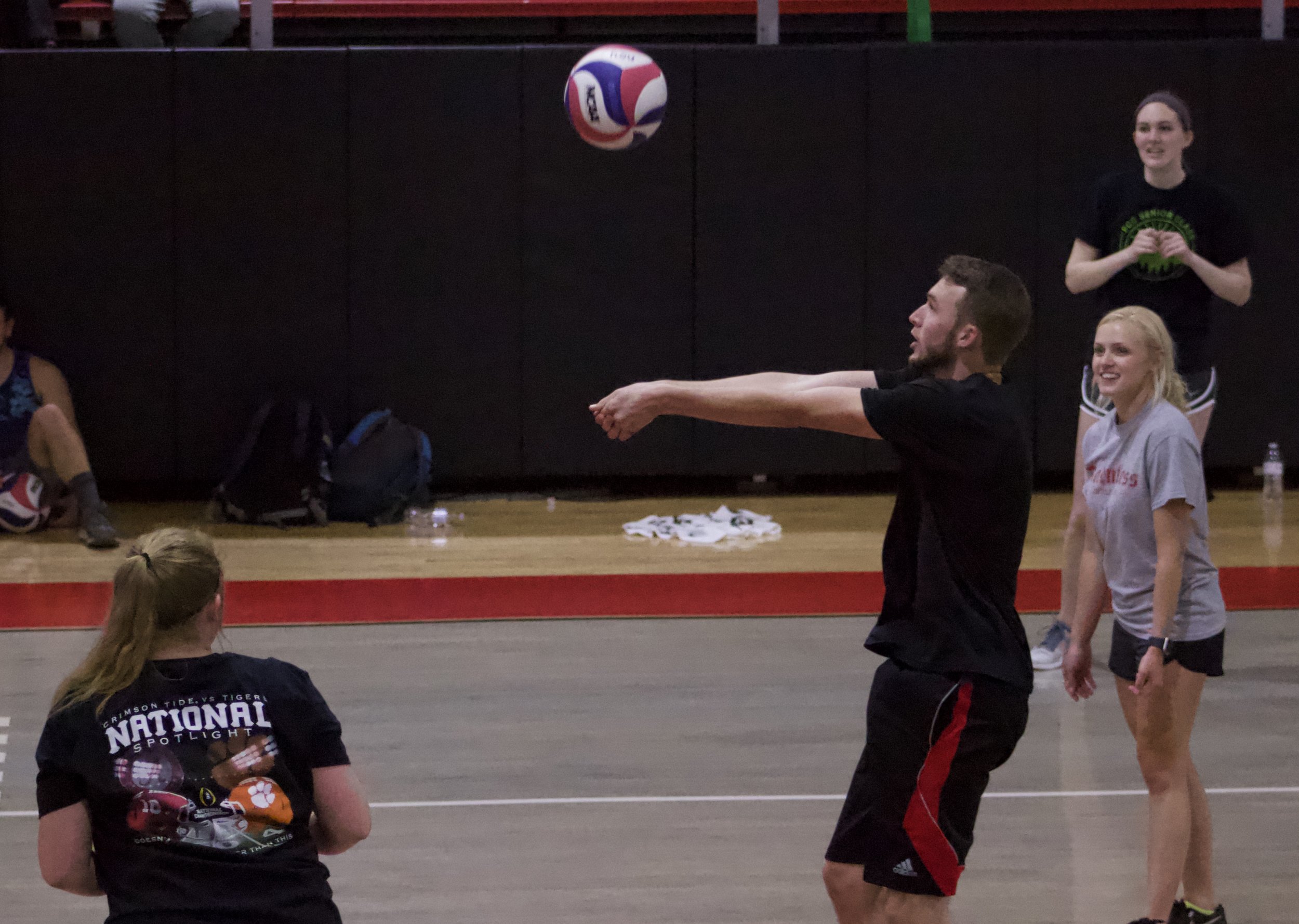 Braden Williams bumping the ball so teammate Bethany Nelson can spike it.&nbsp;