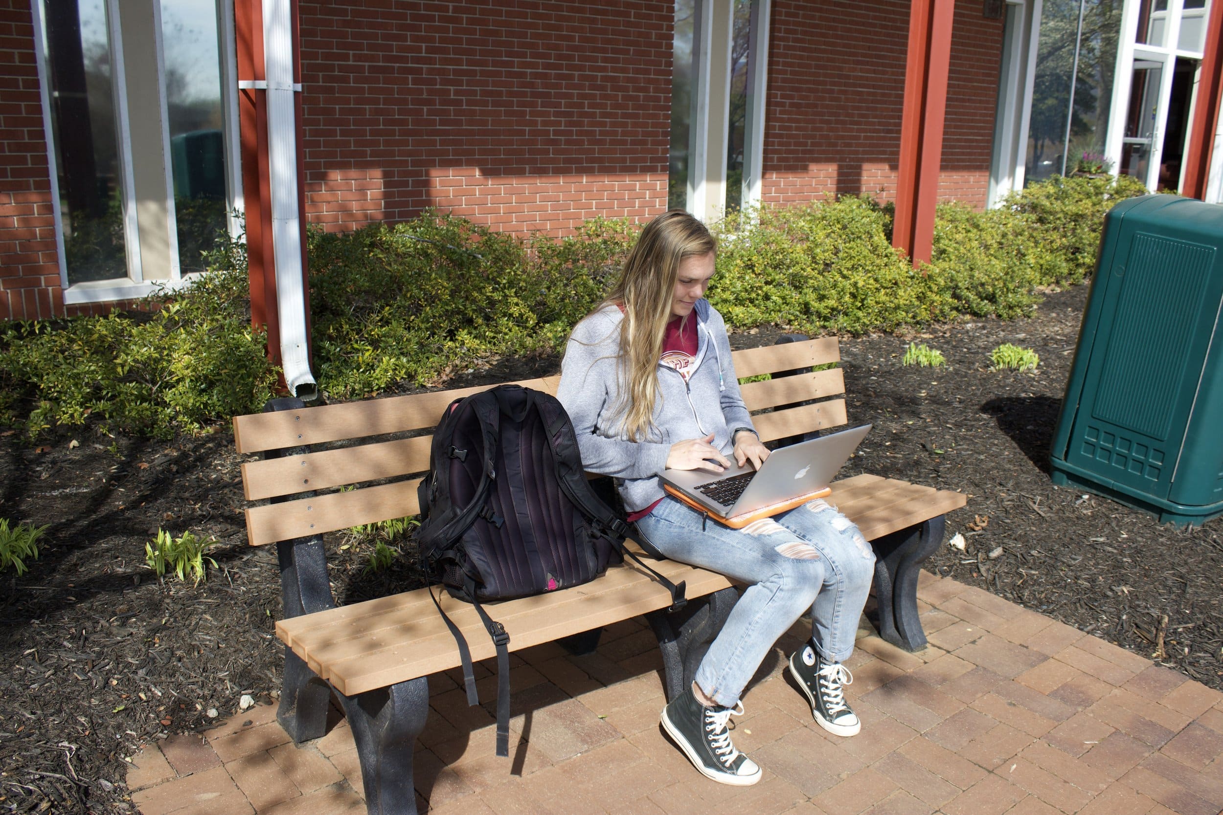 Senior Leah Austin takes advantage of the good weather while studying for exams.&nbsp;