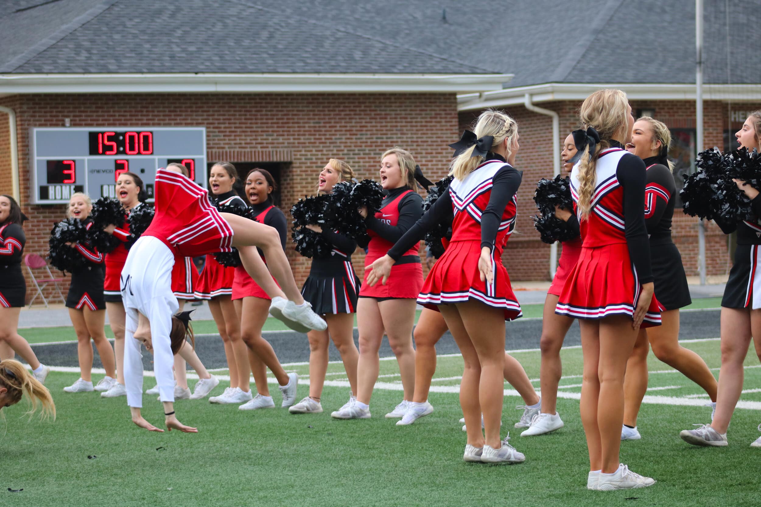 The NGU Cheerleaders do a cheer as they wear their current and previous cheerleading outfits from previous years, including when NGU was NGC (North Greenville College).