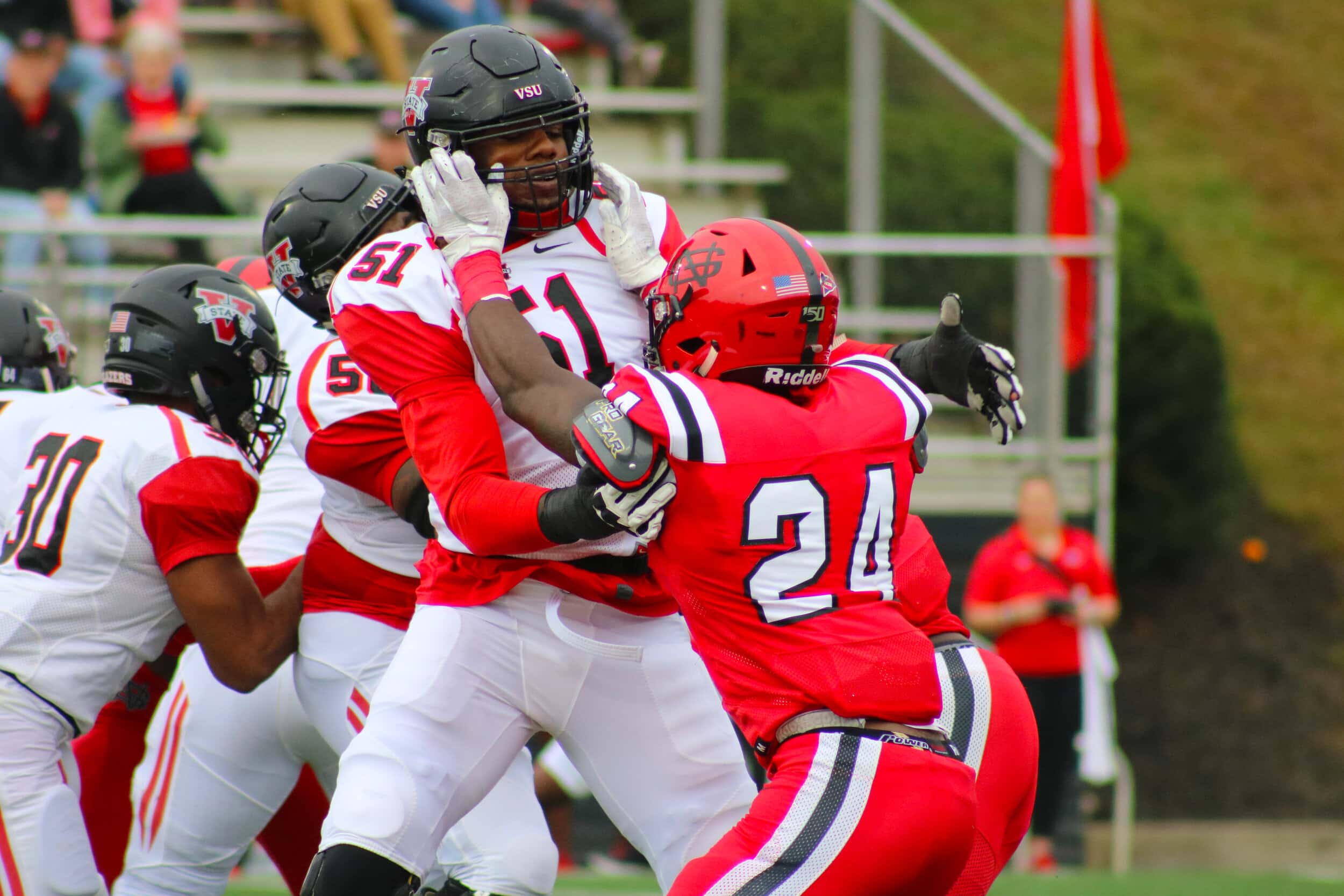 Freshman Micah Bryant (24) fights off a Blazer after the whistle was blown.